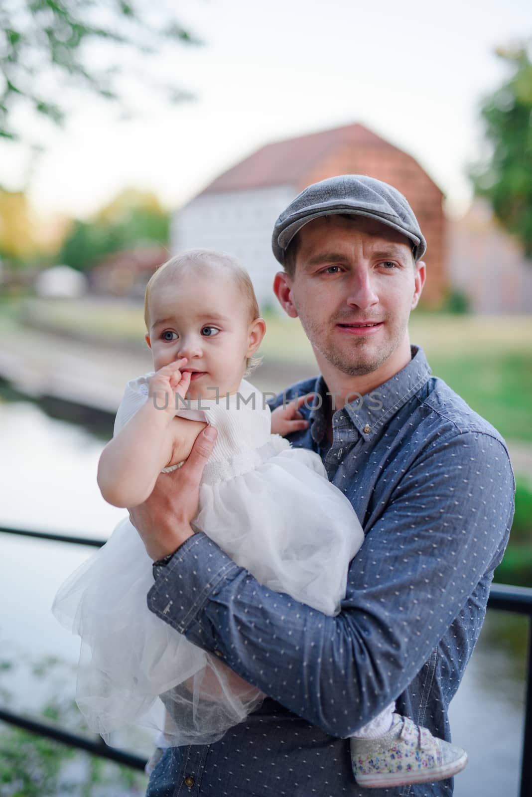 Happy loving family. Father and his daughter child girl playing and hugging outdoors. Authentic lifestyle. Concept of Father's day.