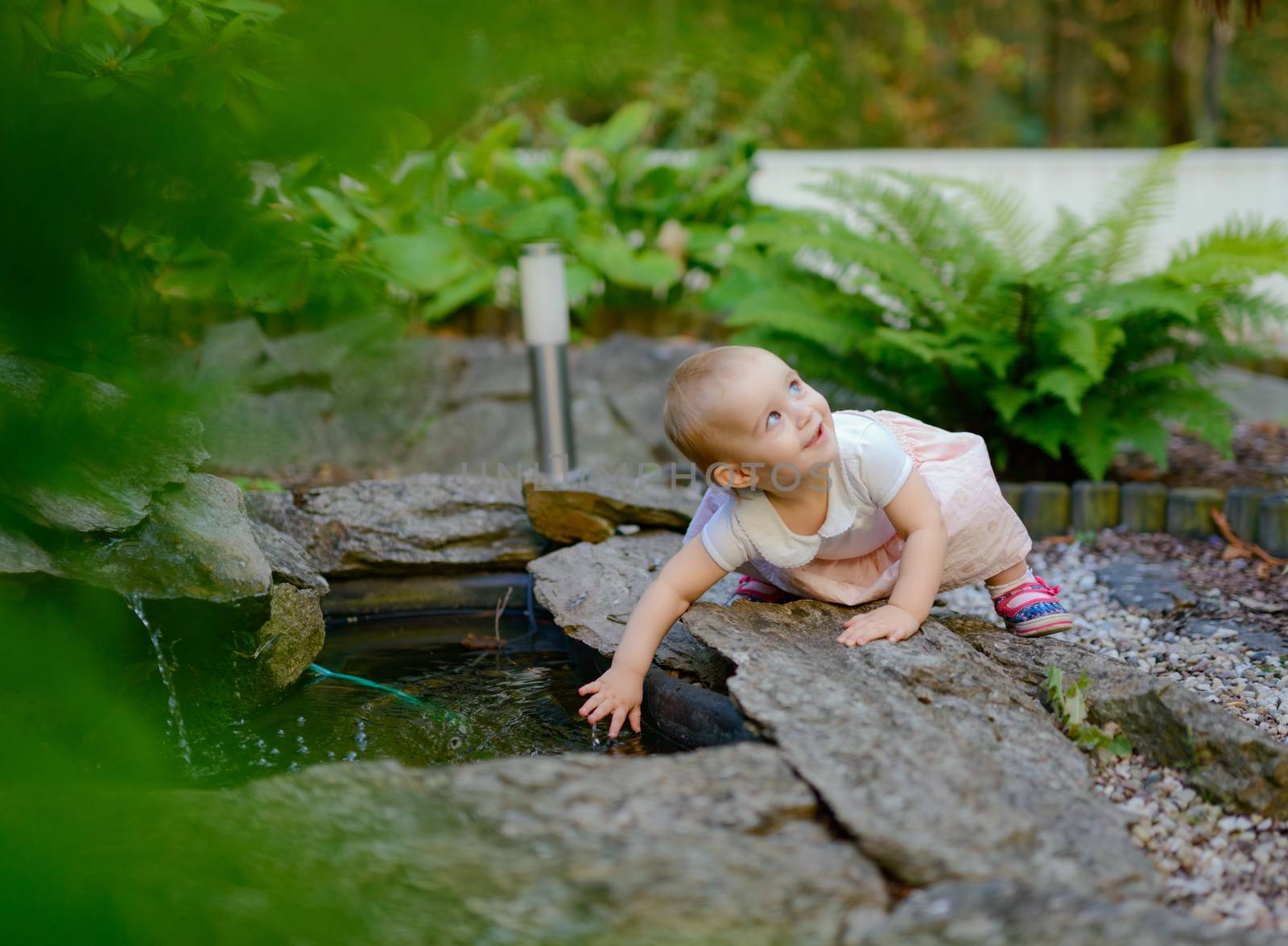 Smiling girl in the park in summer time. Authentic lifestyle image