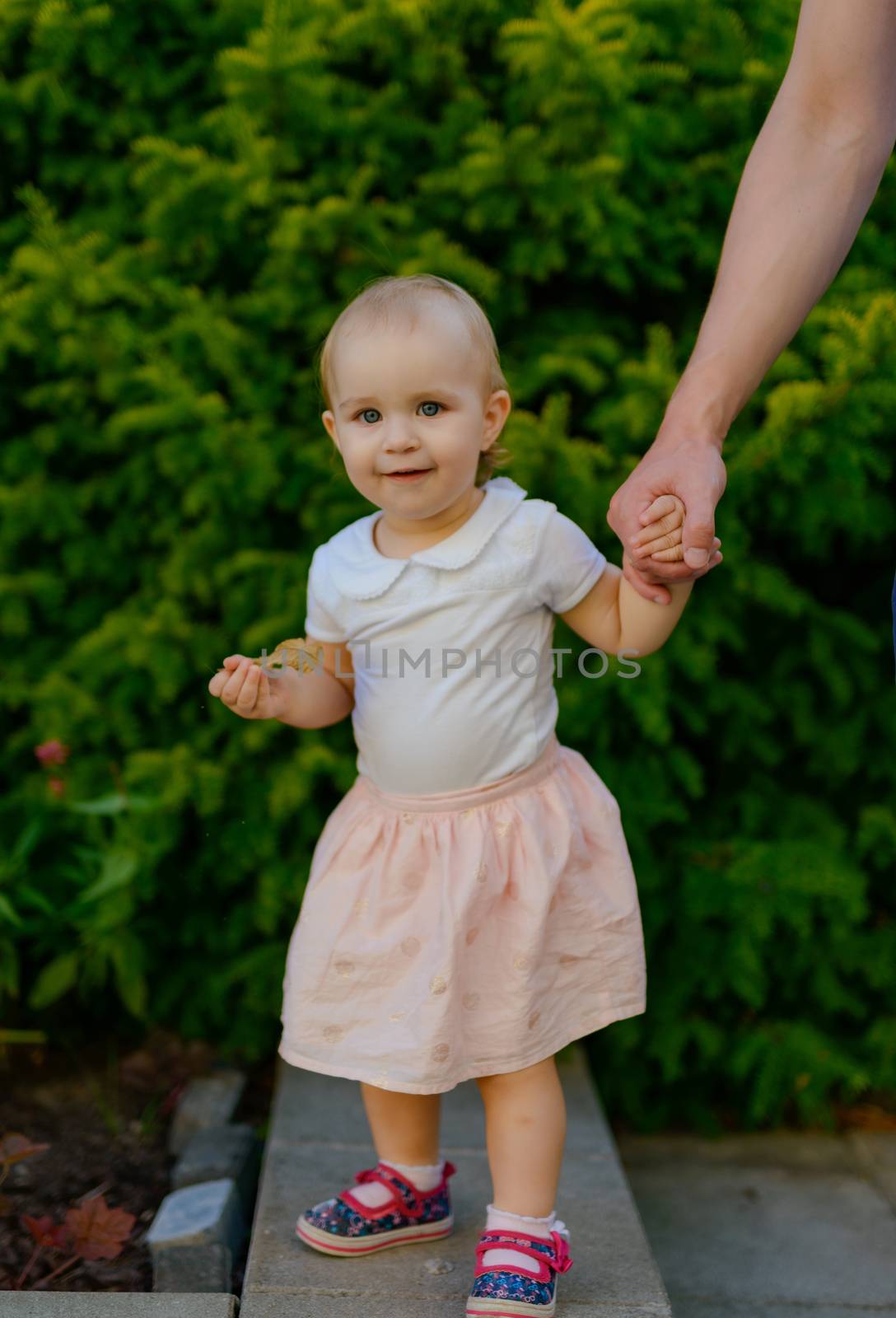 Smiling girl in the park in summer time. Authentic lifestyle image