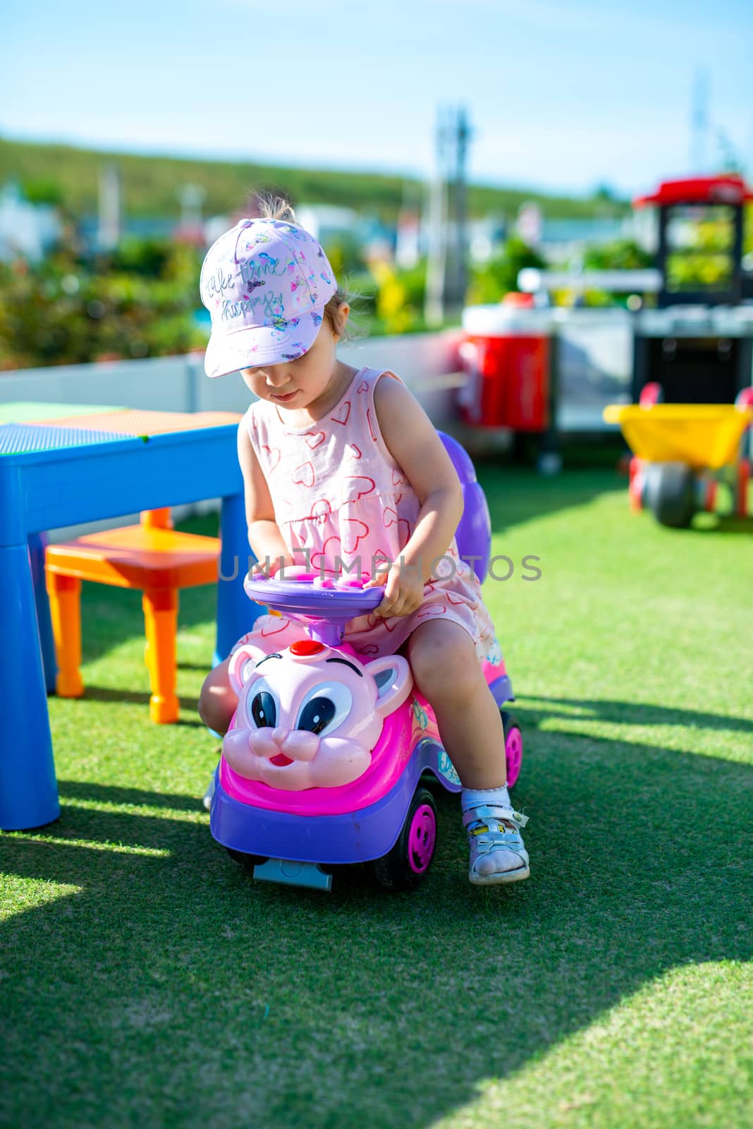 Little girl spending fantastic time on playground. Happy childhood.