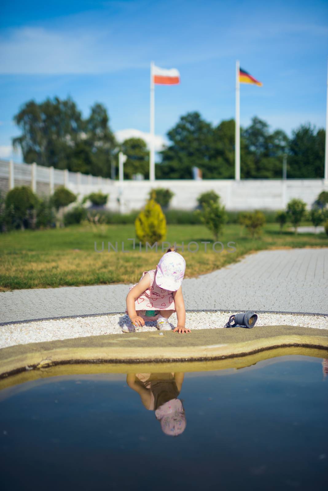 Little girl spending fantastic time on playground. Happy childhood. Authentic image