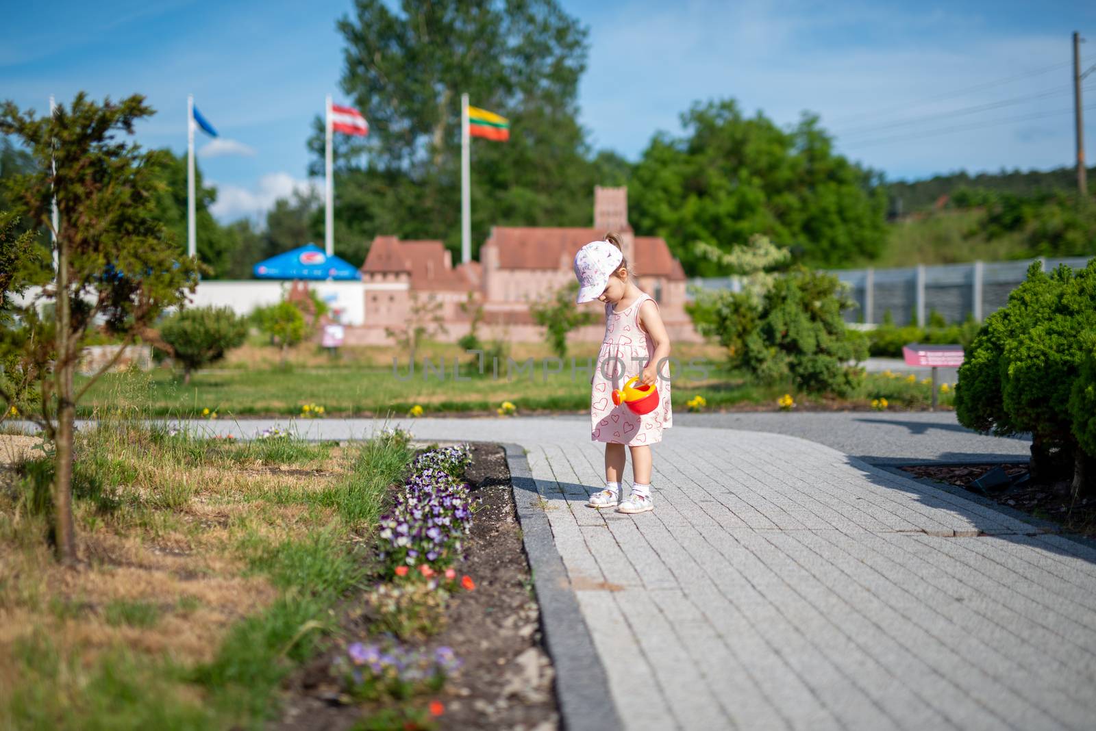 Little girl spending fantastic time on playground. Happy childhood. Authentic image