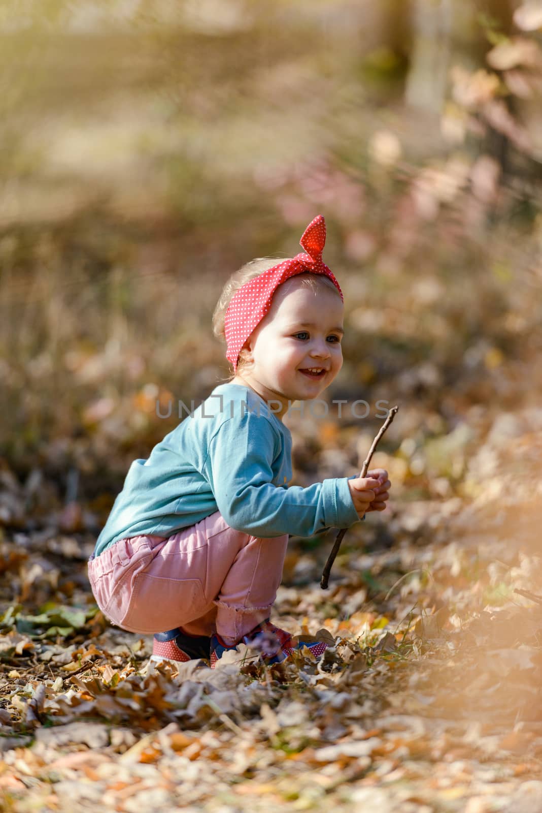 Adorable girl having fun on beautiful autumn day. Authentic picture.