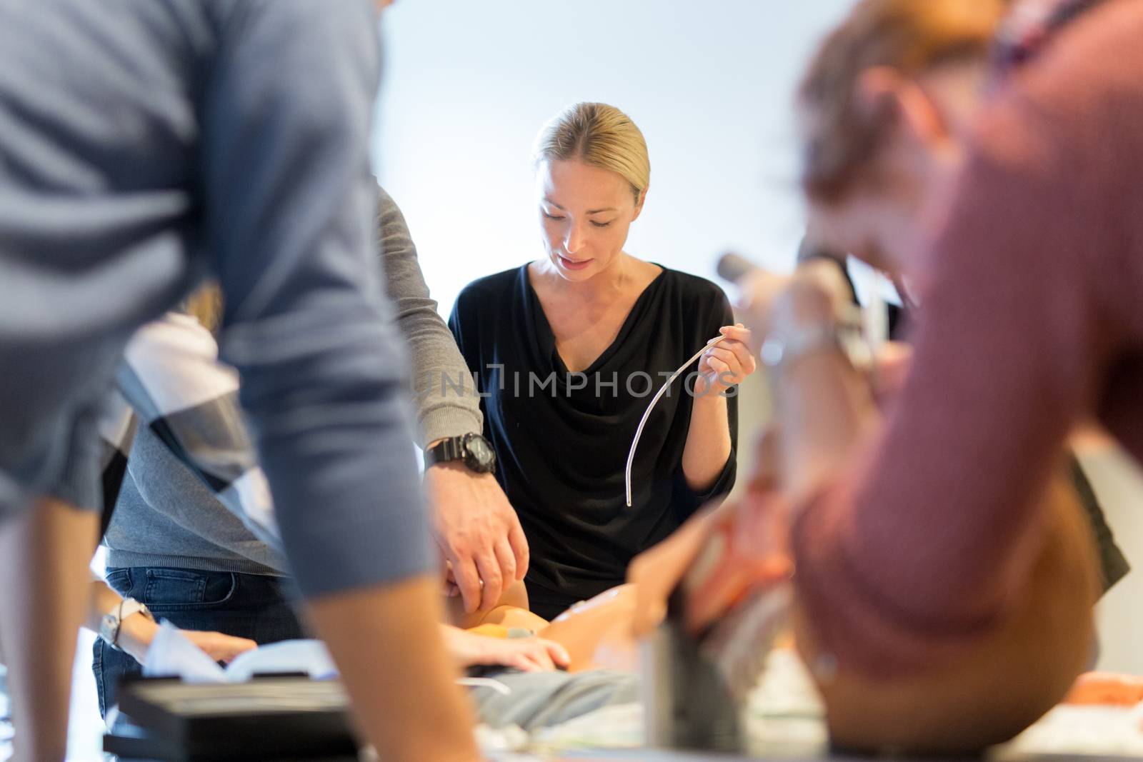 Medical doctor specialist expert displaying method of patient intubation on hands on medical education training and workshop. Participants learning new medical procedures and techniques. by kasto