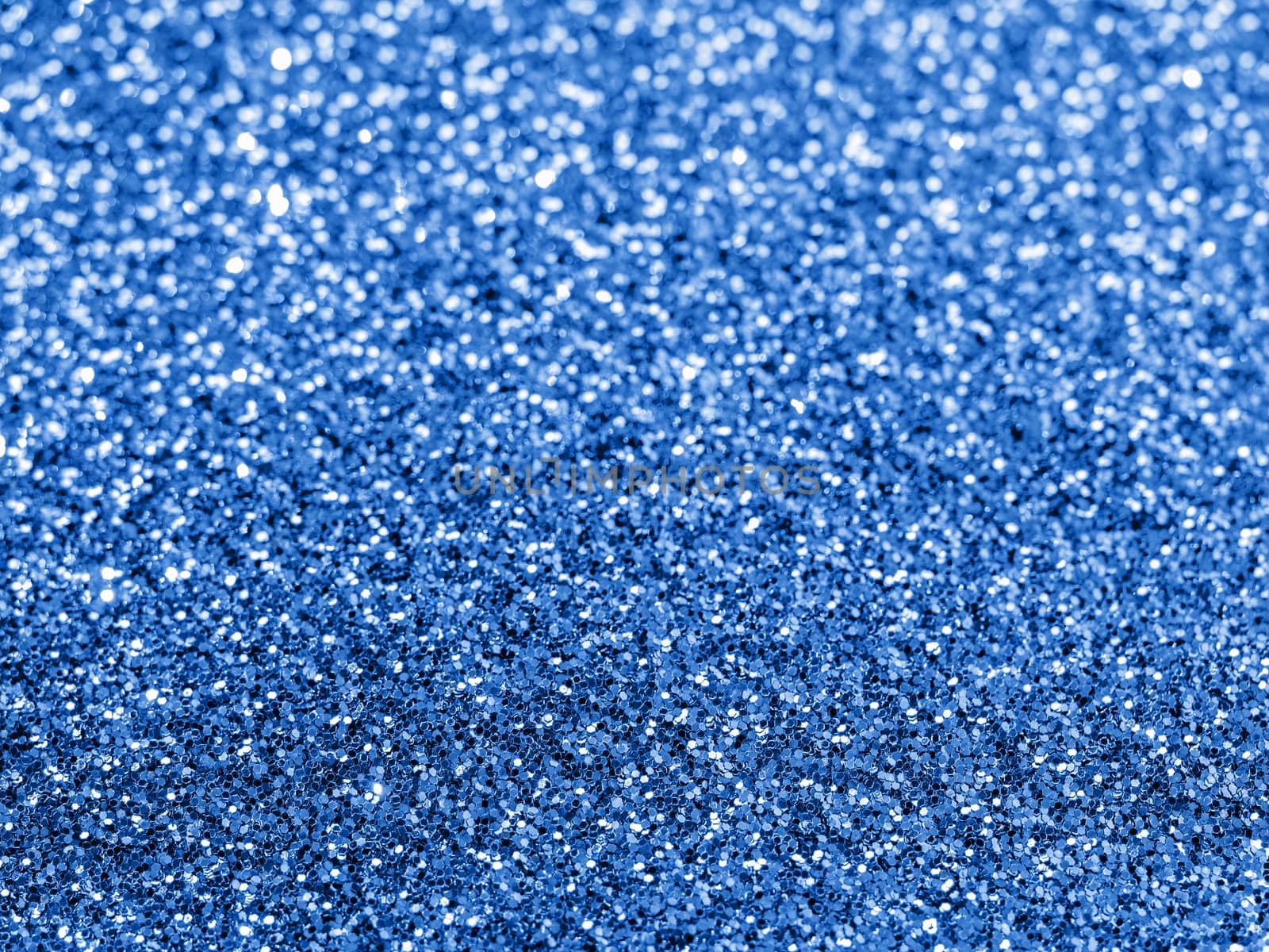 Sparkling background with bokeh made of Classic Blue 2020 color. Color of year 2020 blurred backdrop for holidays and parties. COY2020 Classic Blue concept. Copy space for text