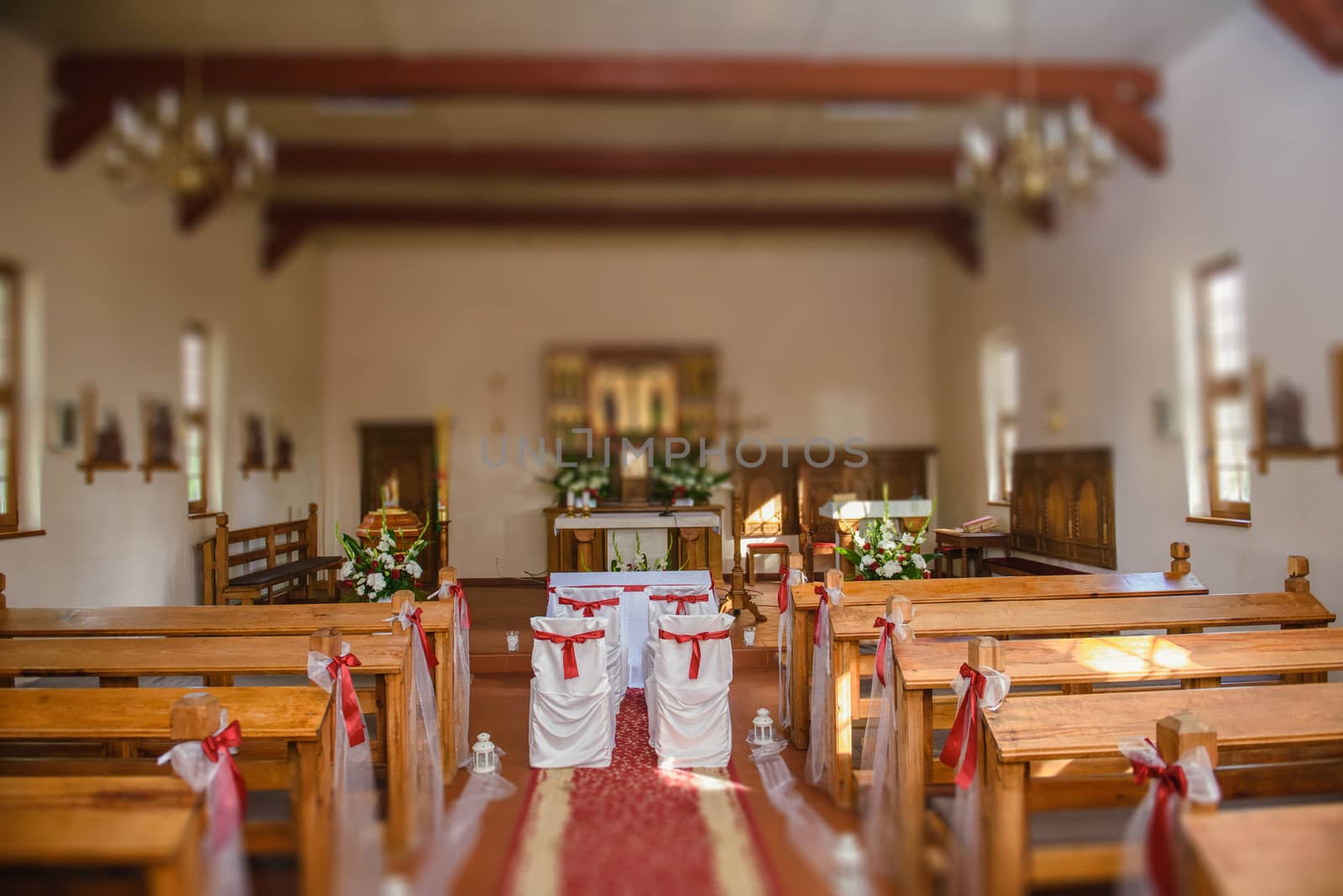 Church sanctuary before a wedding ceremony. Empty chairs for bride and groom