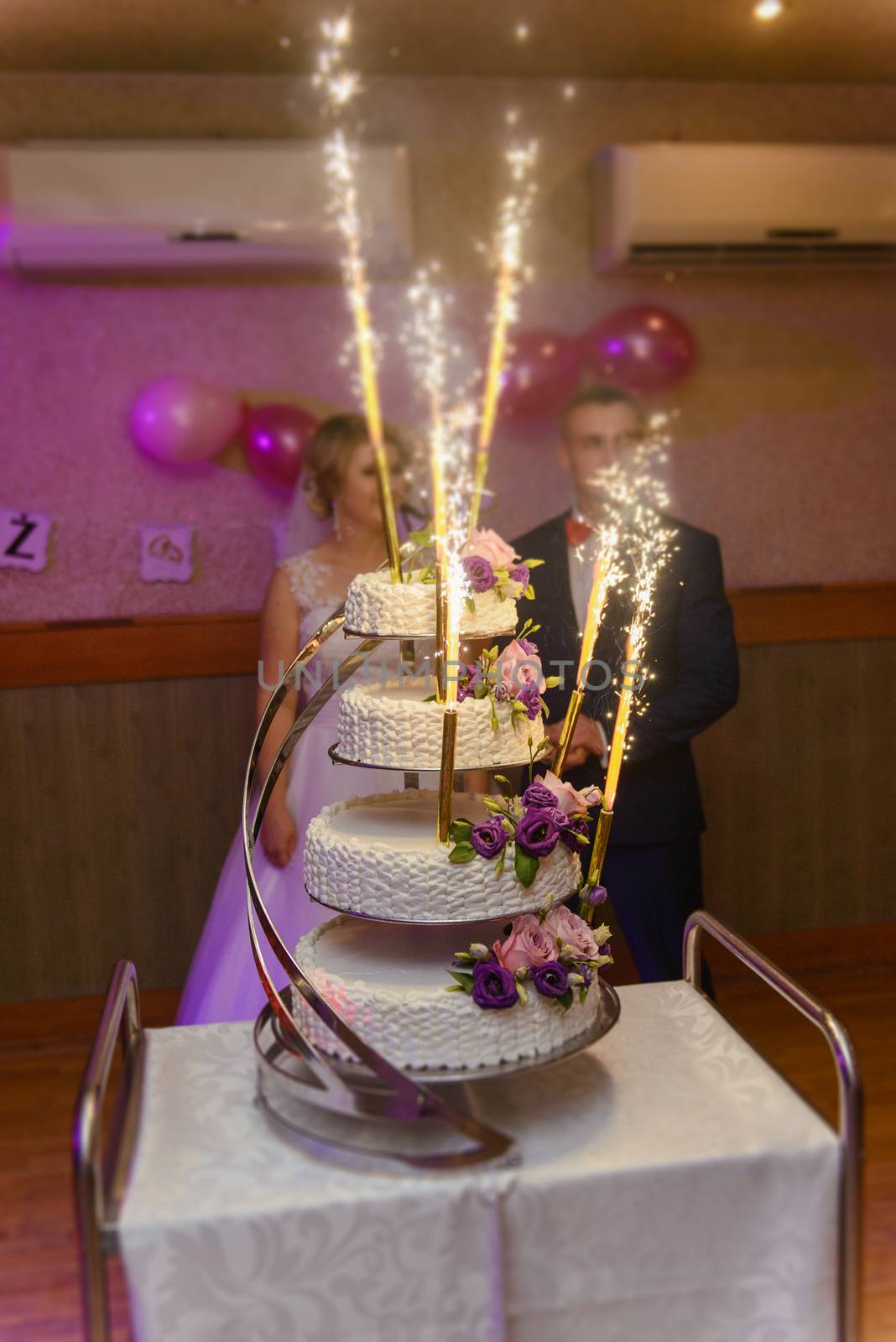 Delicious Wedding Cake at the party. Smoke and fire effects