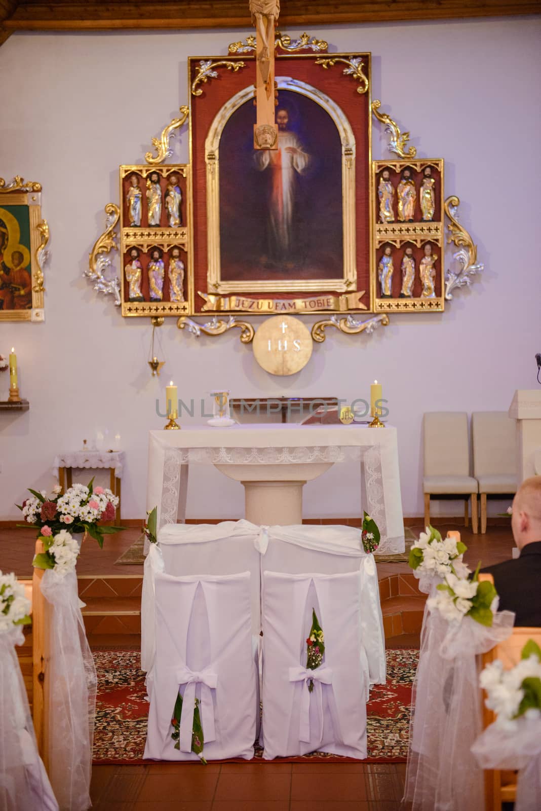 Church sanctuary before a wedding ceremony. Empty chairs for bride and groom