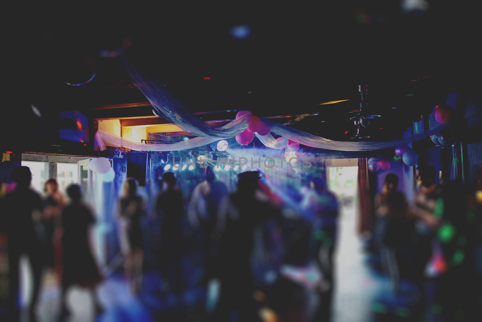 Bride and groom dancing the first dance at their wedding day. Guest on the dancefloor