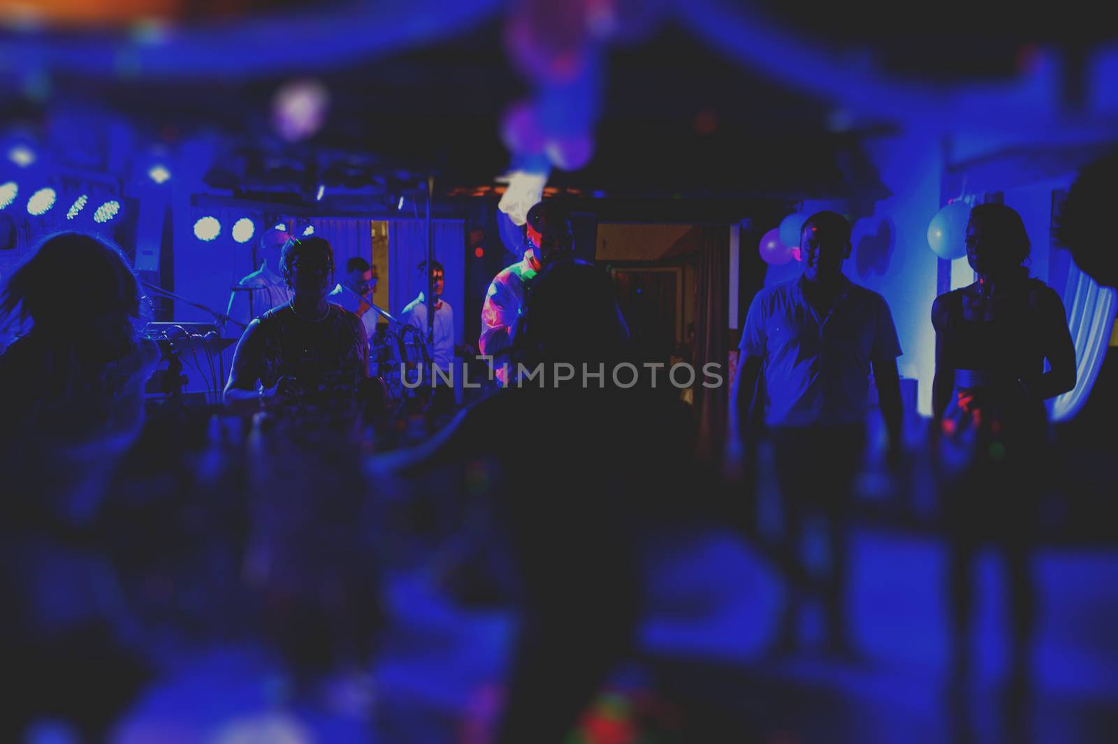 Bride and groom dancing the first dance at their wedding day. Guest on the dancefloor