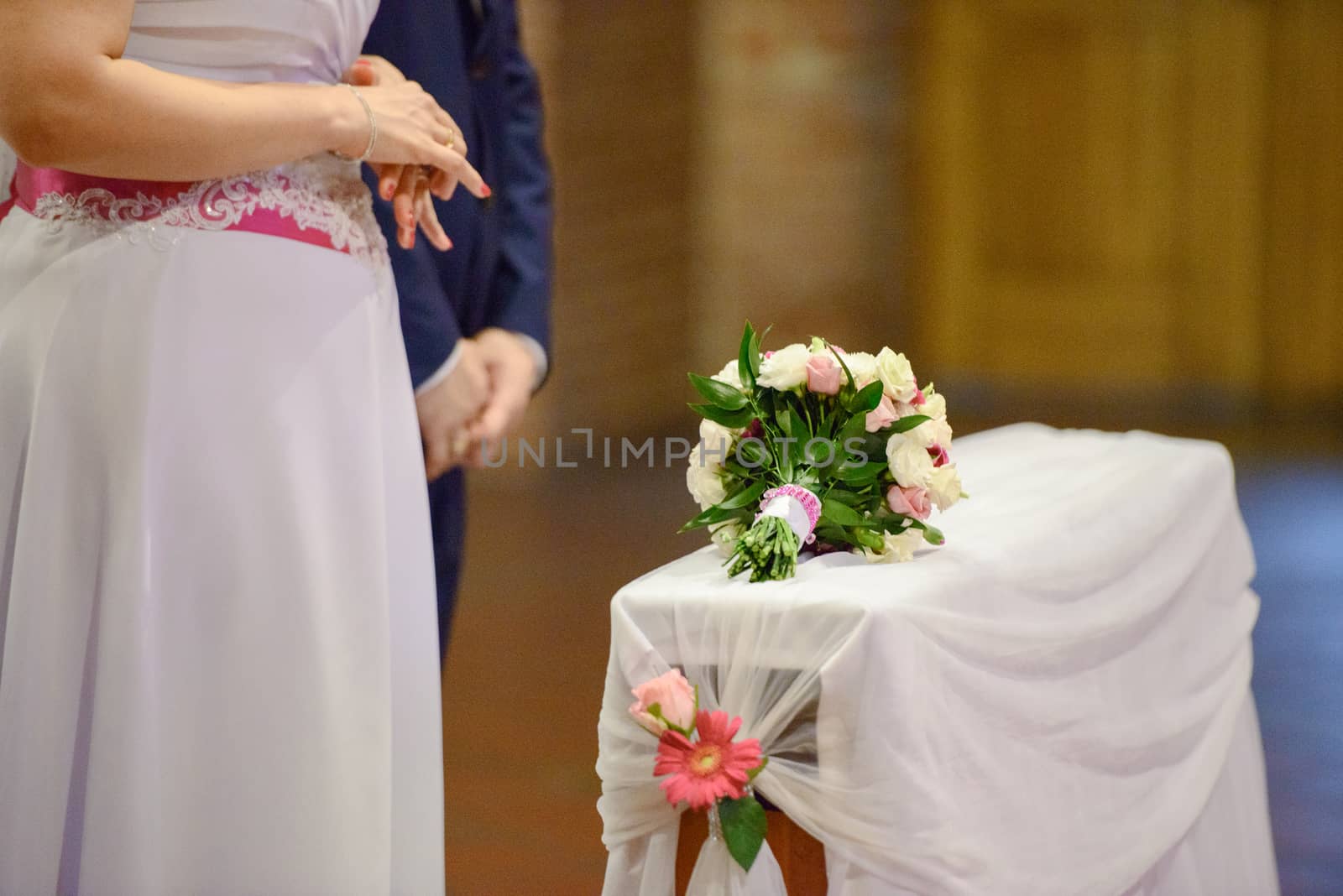 Bride and groom at church wedding during ceremony. Beautiful decoration