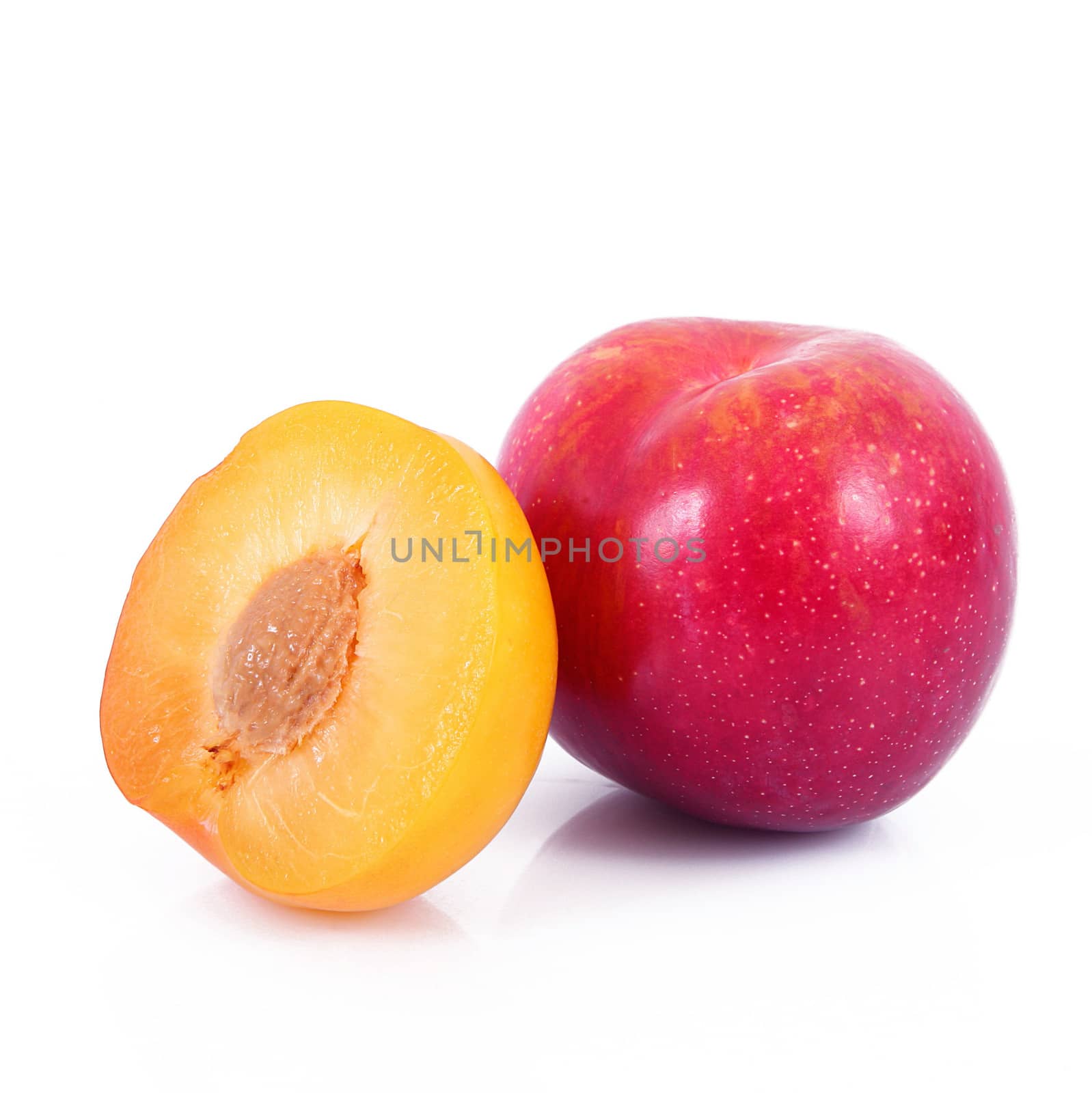 fresh plums on white background