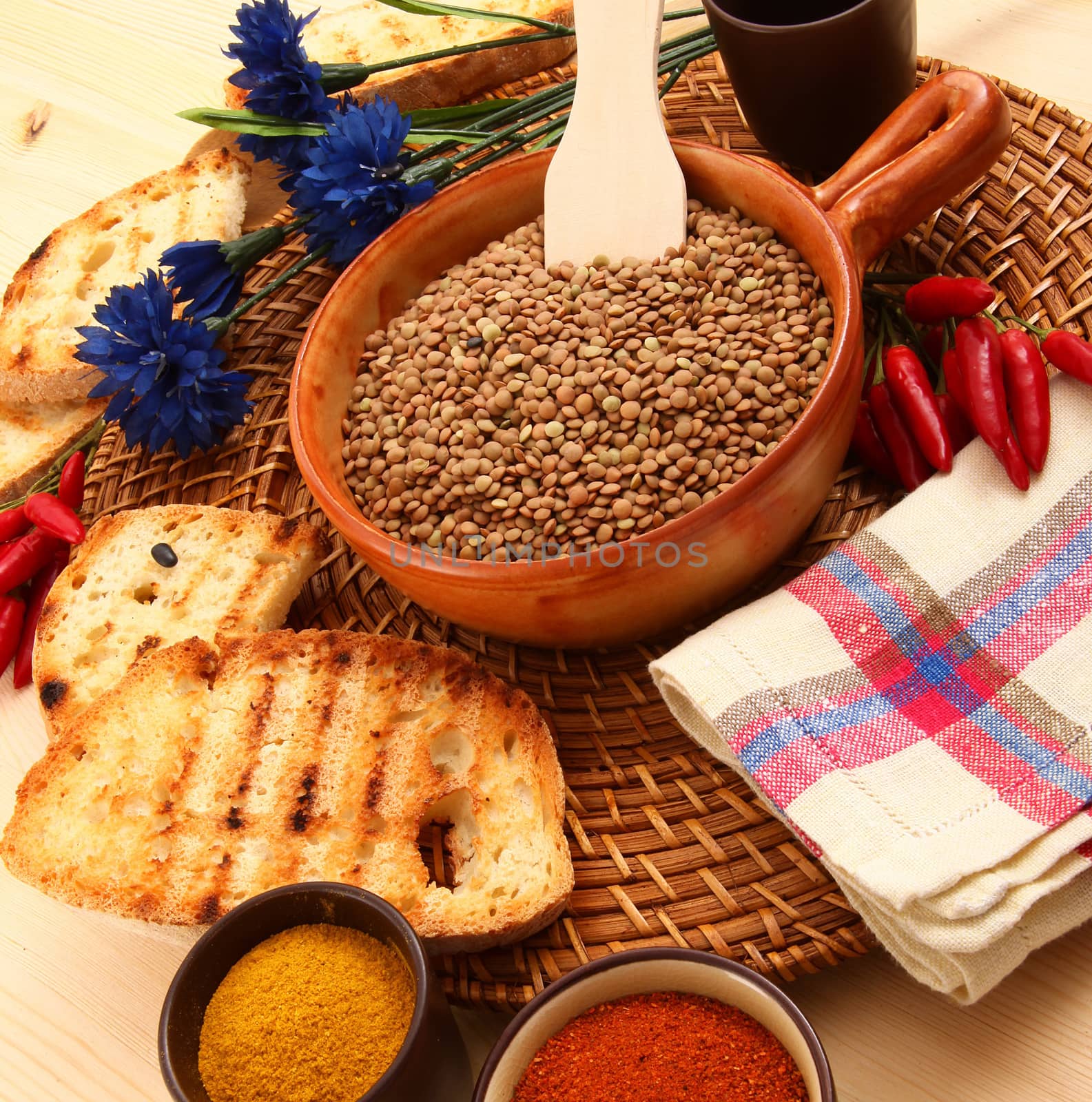 dry lentils in rustic dish on wooden table