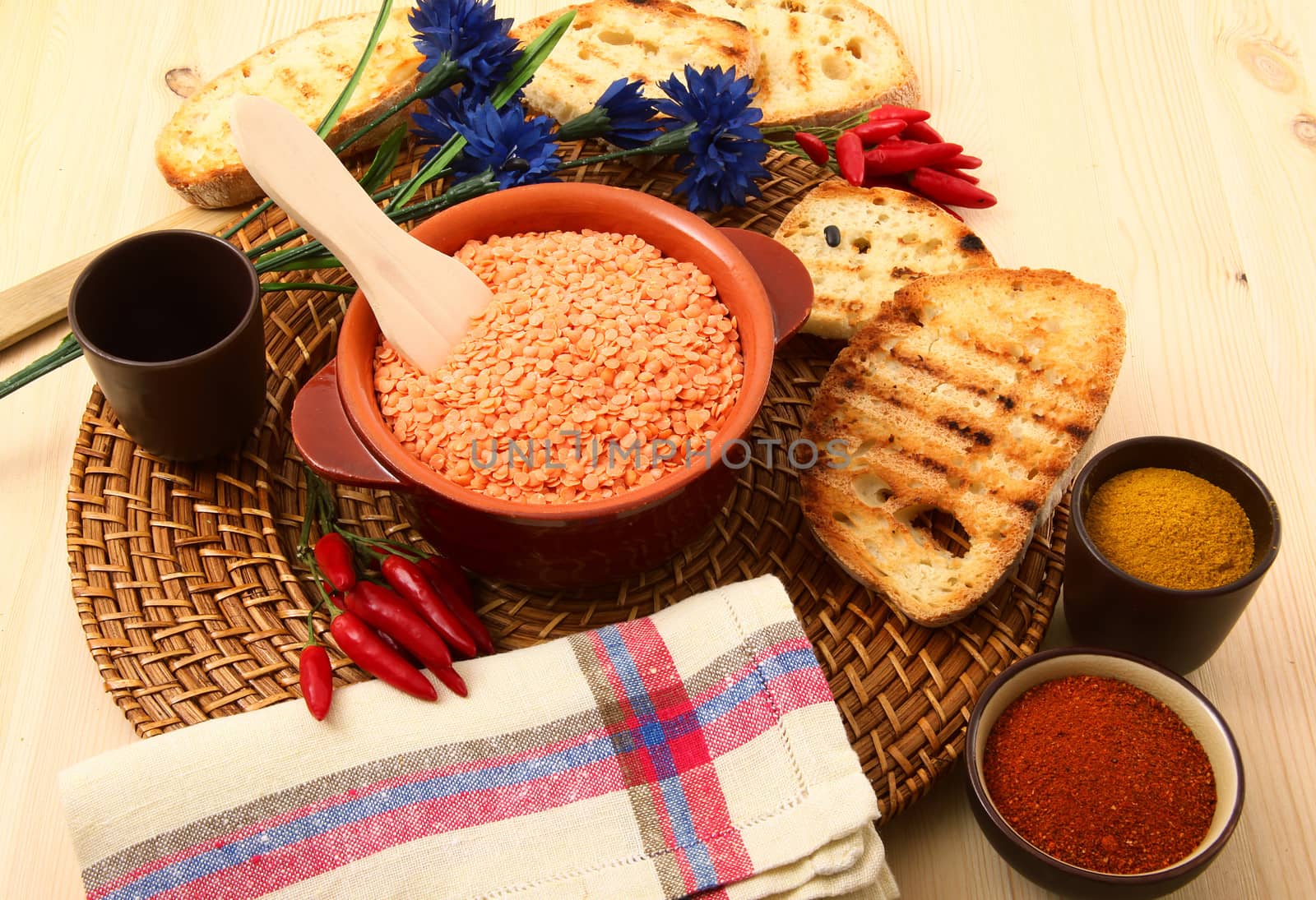dry orange lentils in rustic dish on wooden table