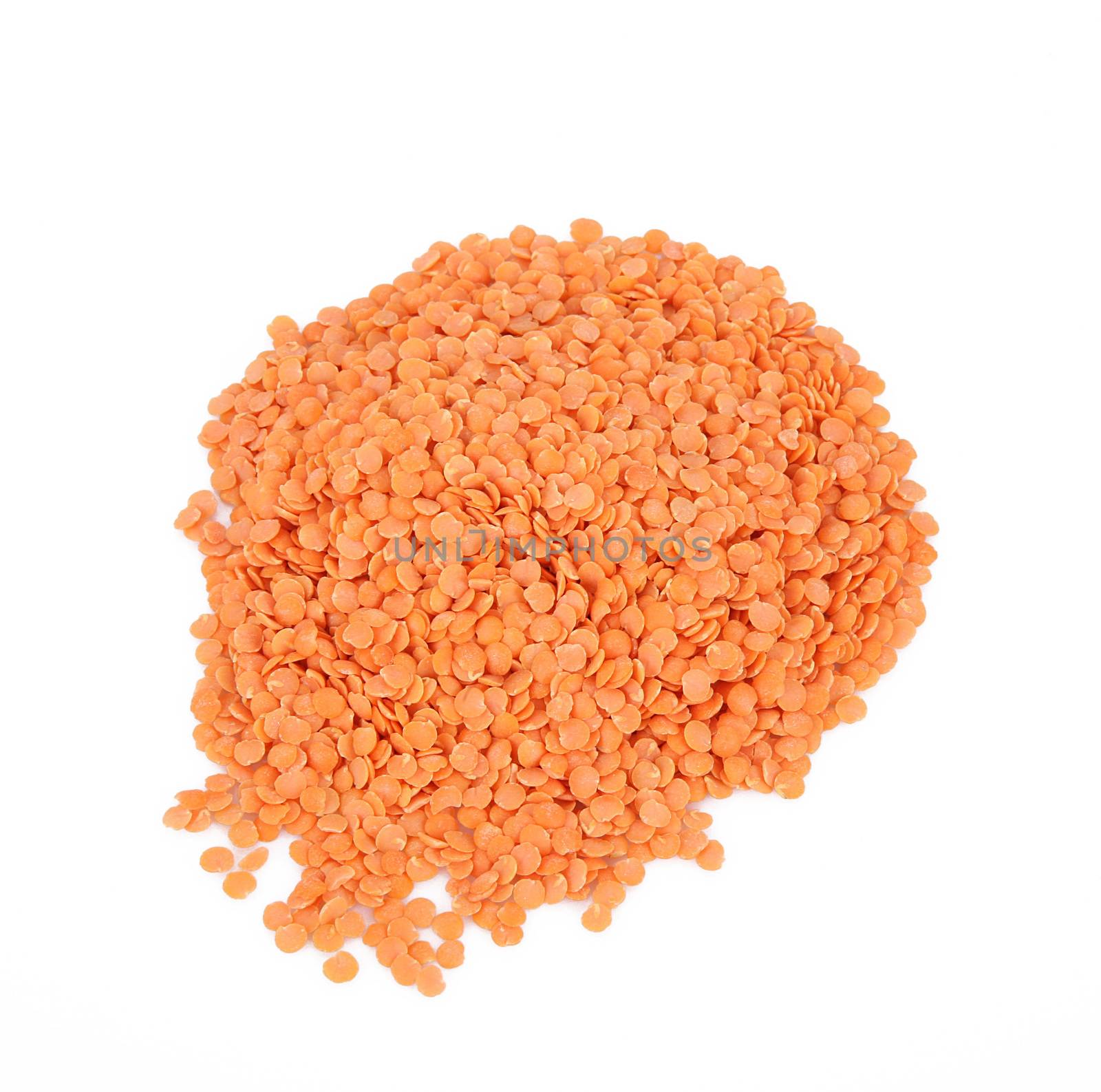 dry orange lentils on white background