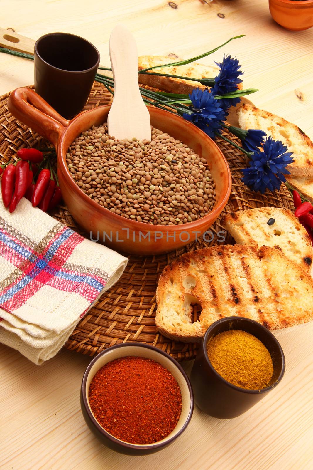 dry lentils in rustic dish on wooden table