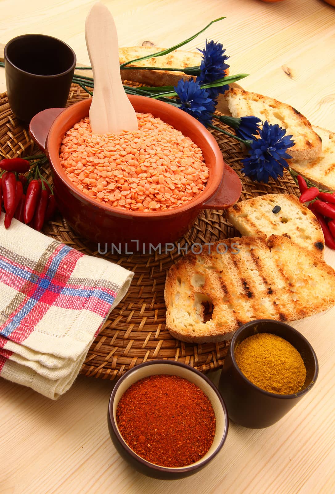 dry orange lentils in rustic dish on wooden table