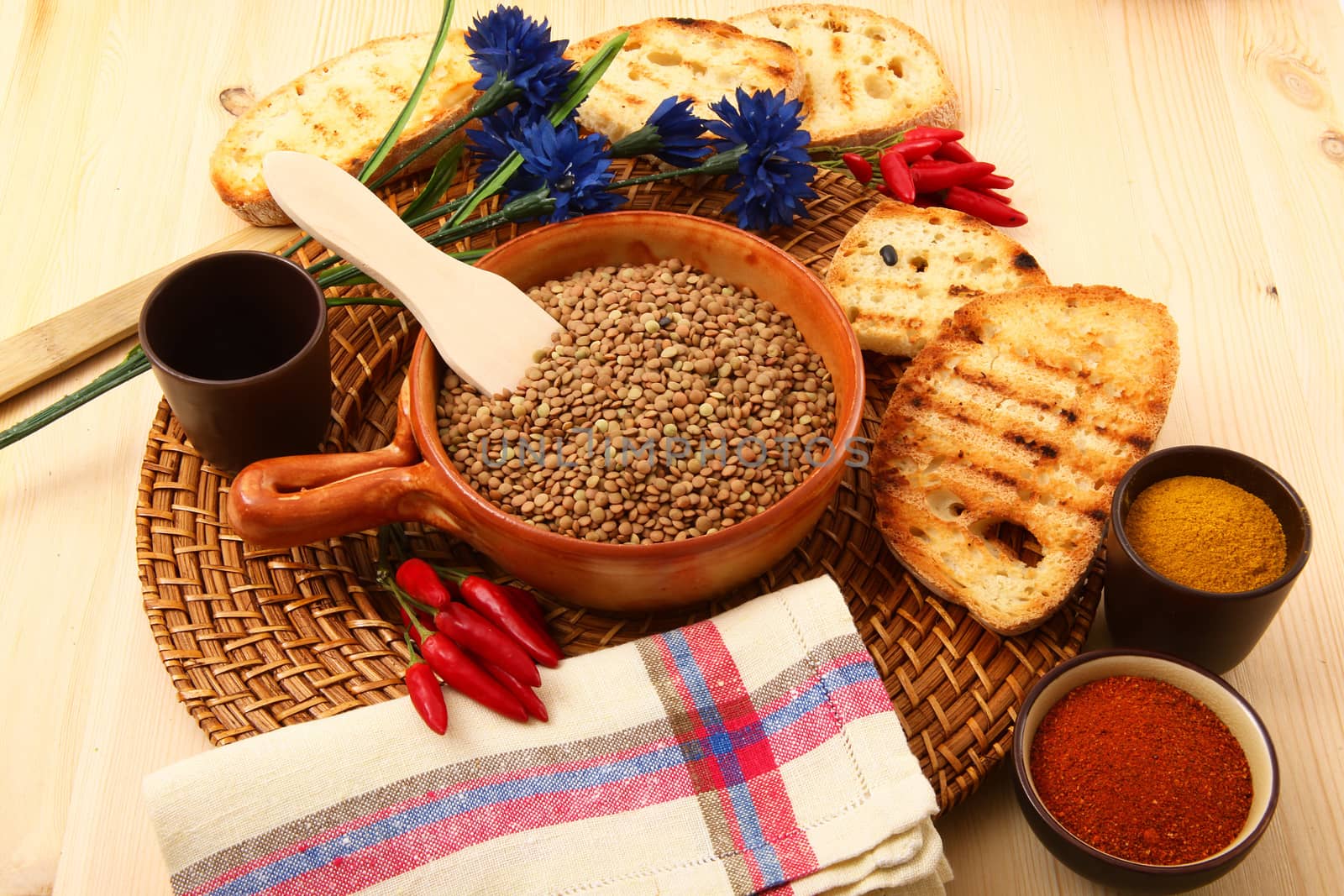 dry lentils in rustic dish on wooden table
