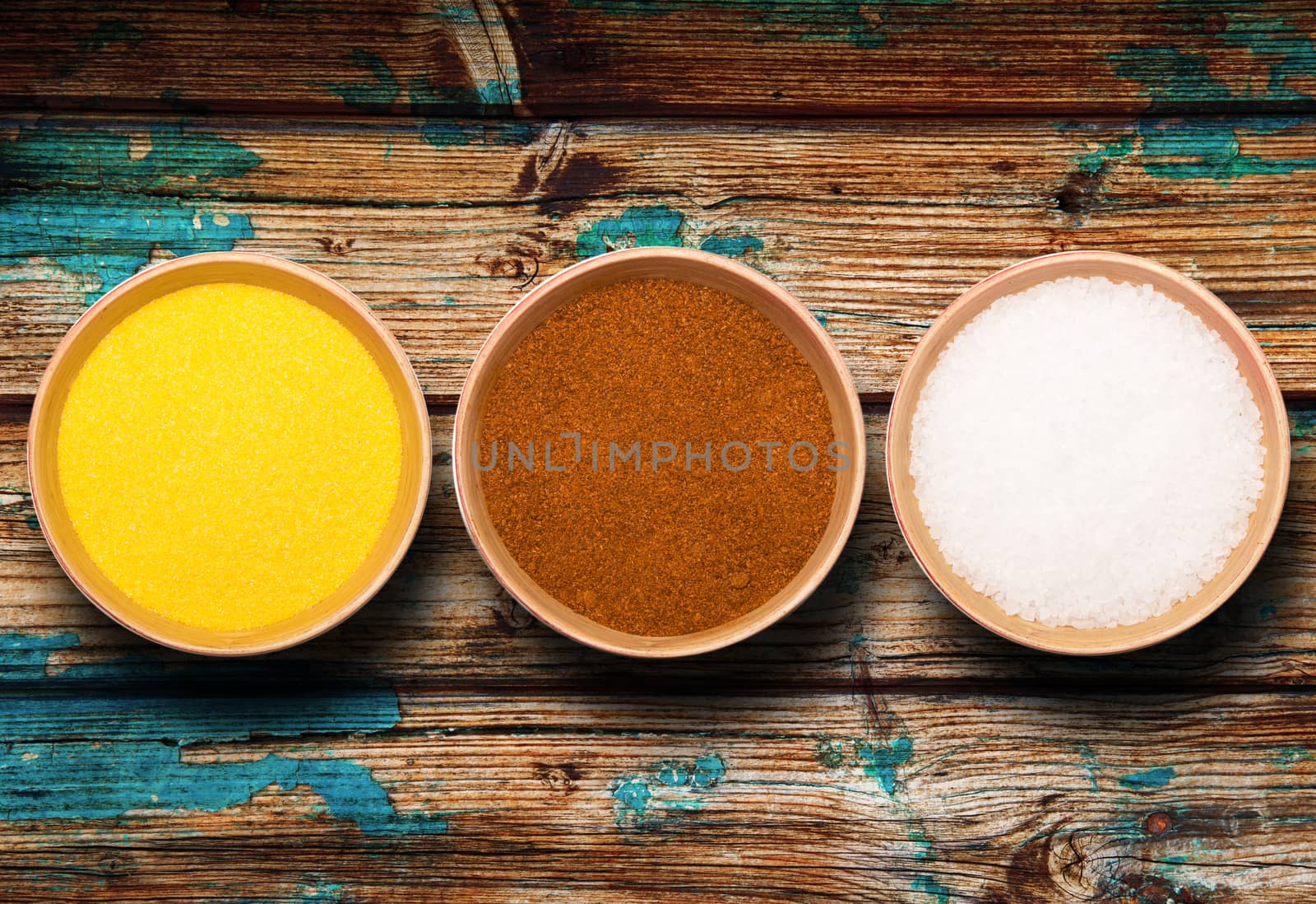 bowls with salt and pepper on dark background