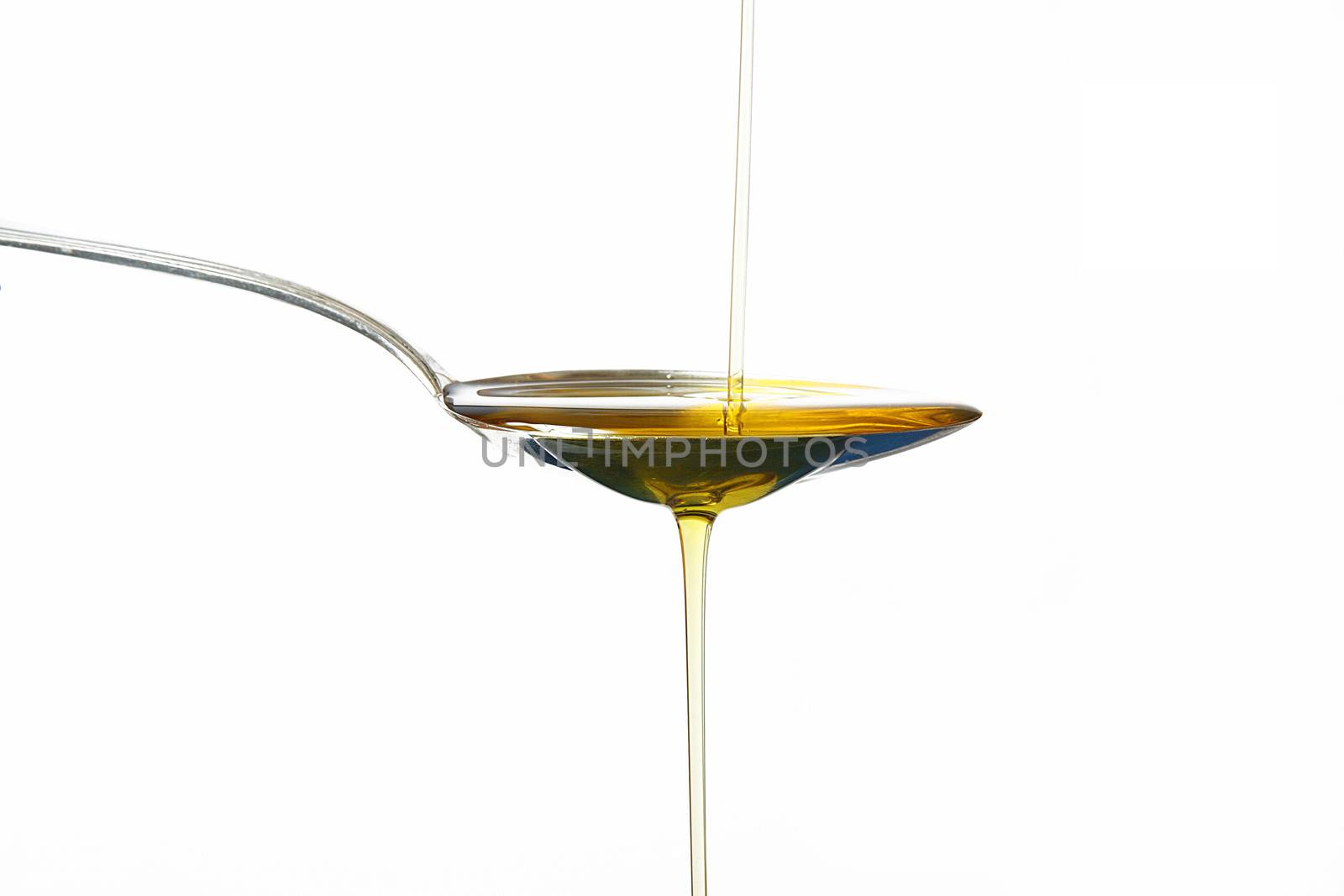 olive oil on spoon on white background
