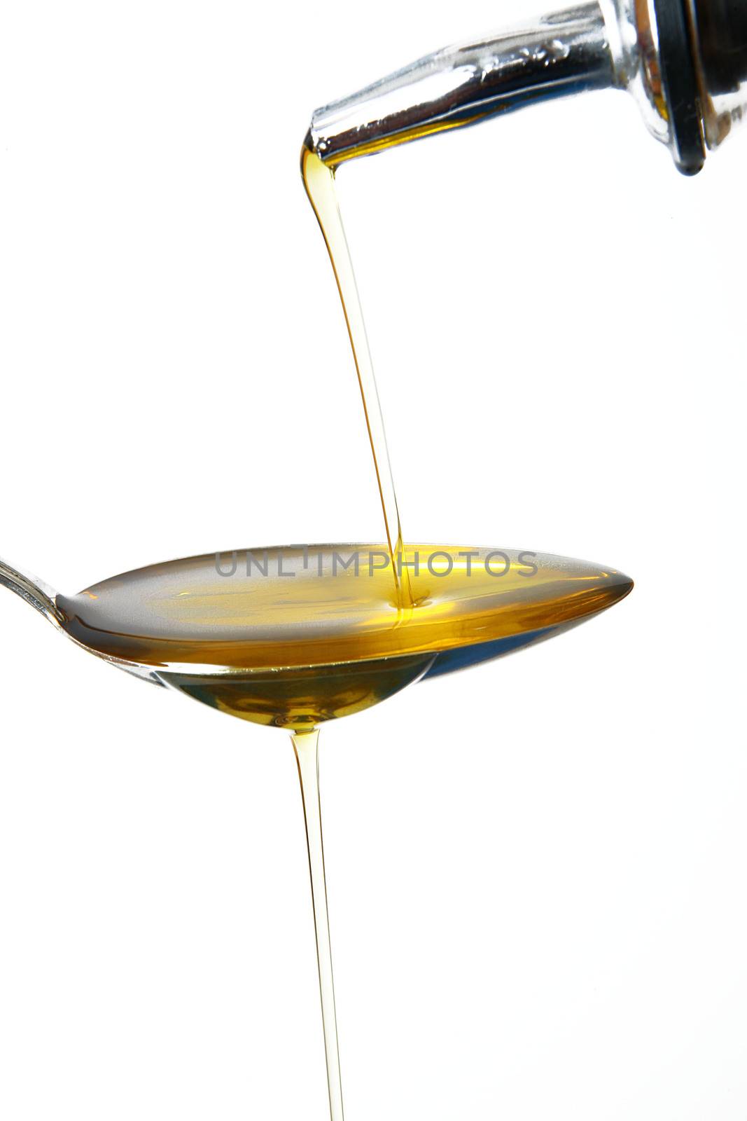 olive oil on spoon on white background