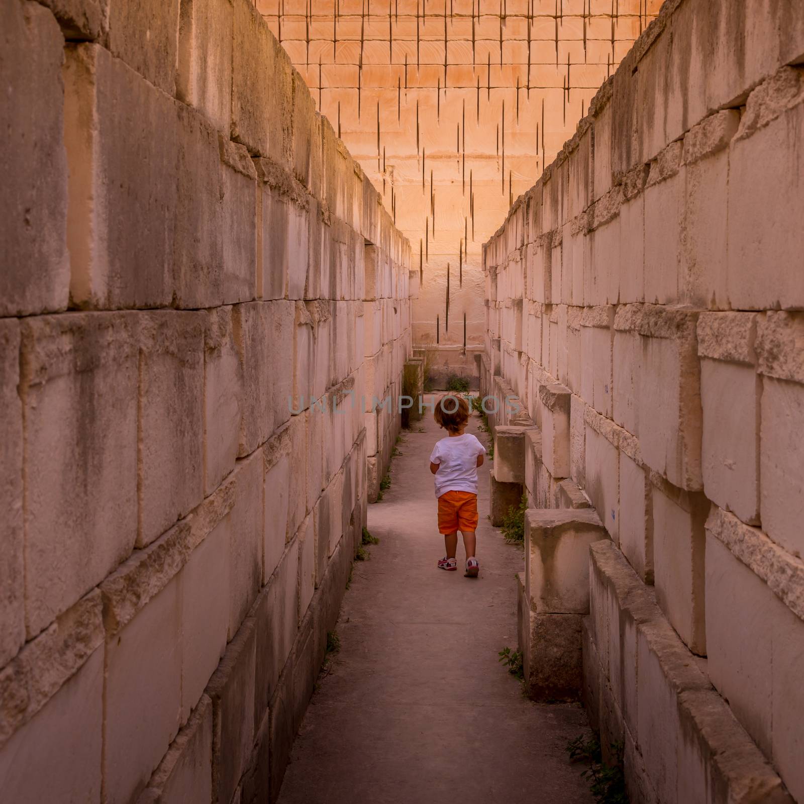 Lonely young boy walking in a corridor by Perseomedusa