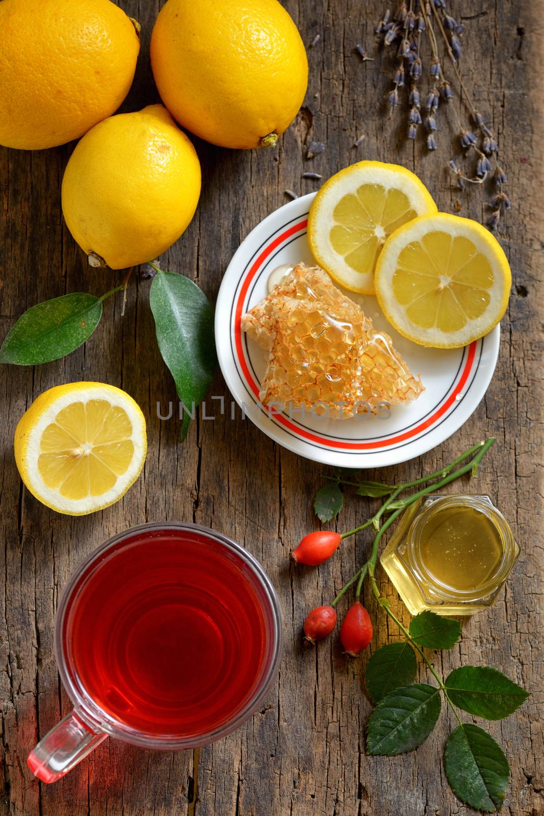 Tea with lemon and honey on wooden background