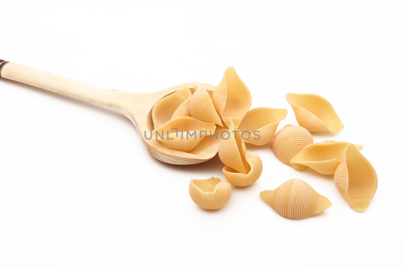 wood spoon with italian raw pasta on white background