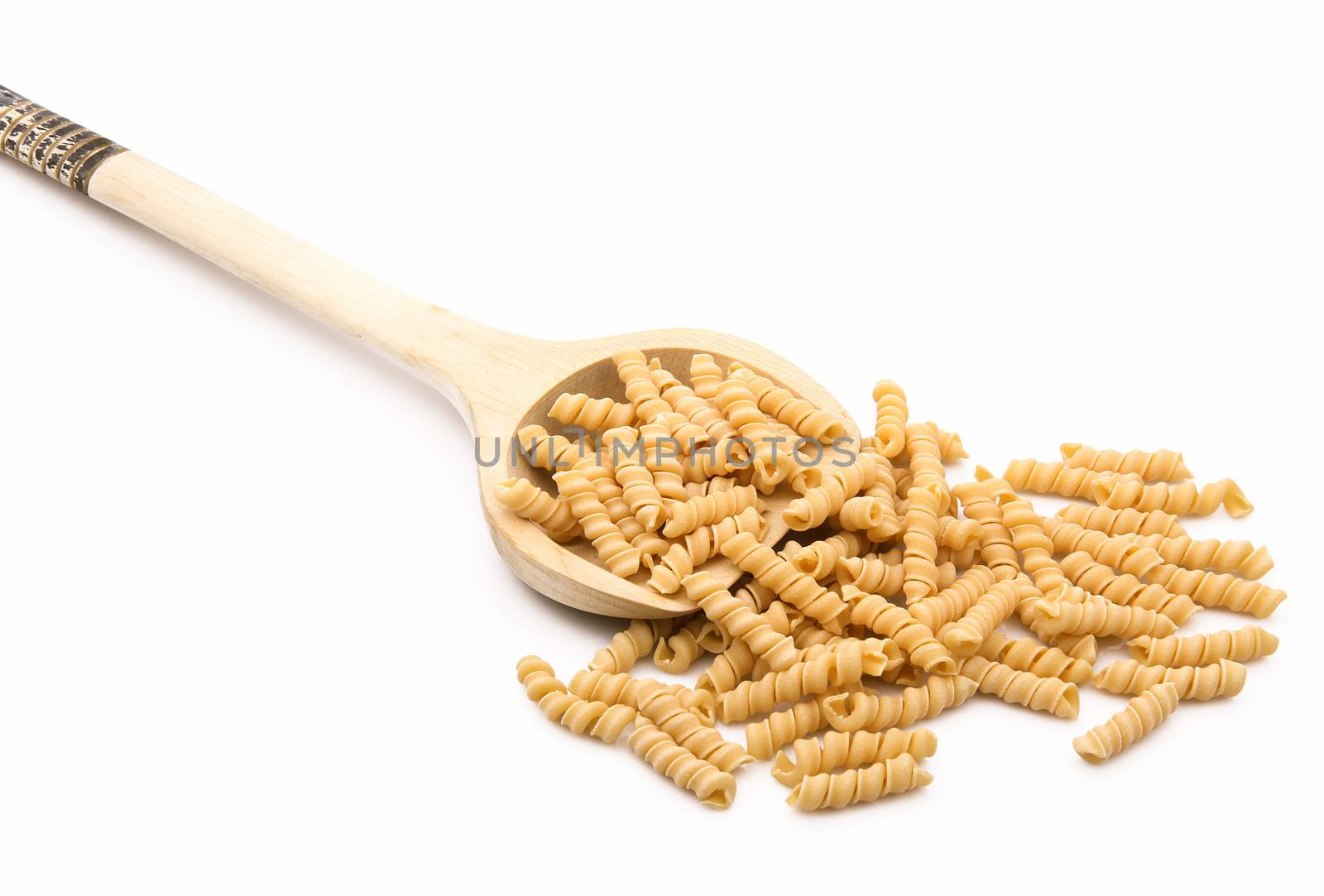 wood spoon with italian raw pasta on white background