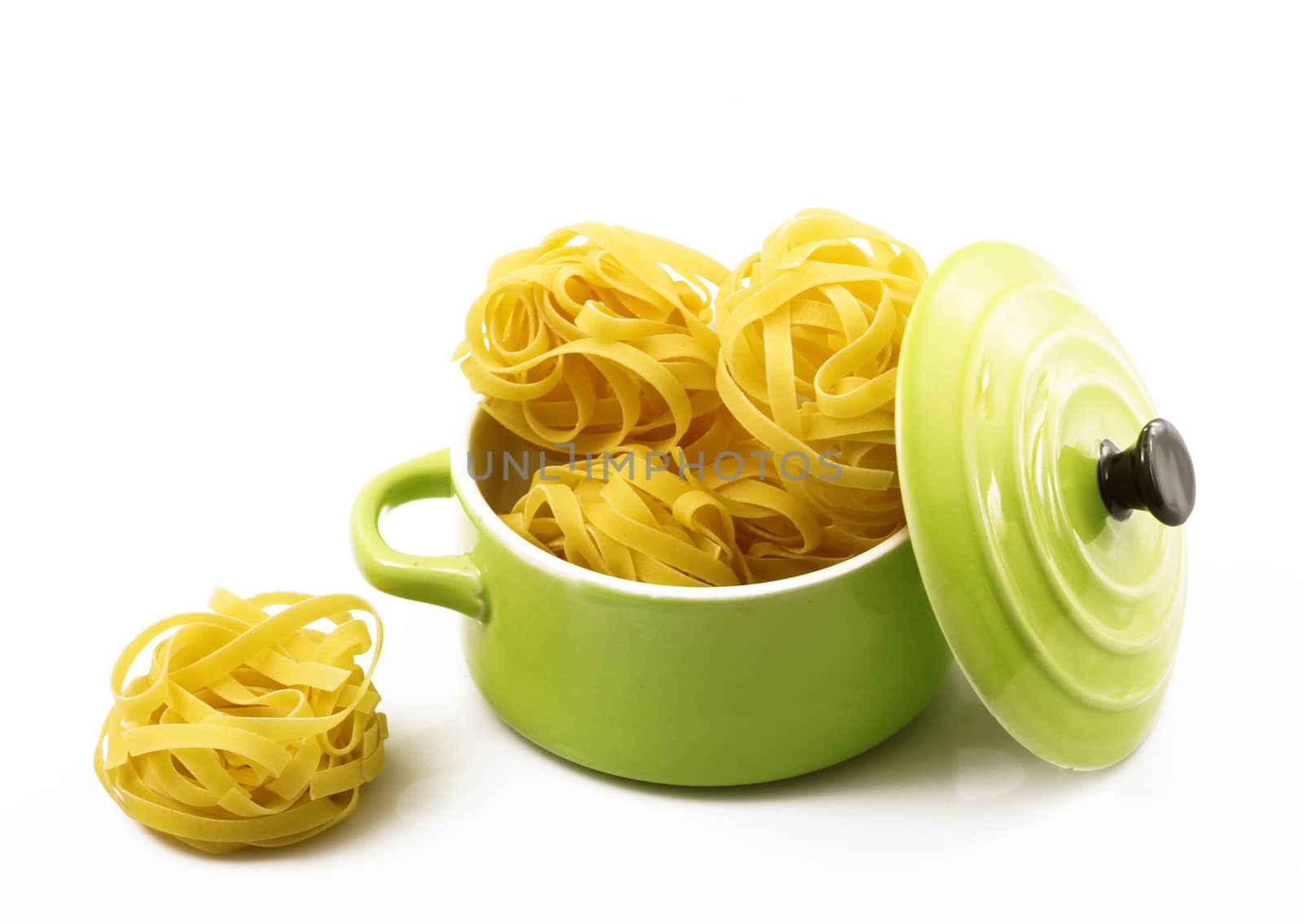 italian raw pasta in green pot