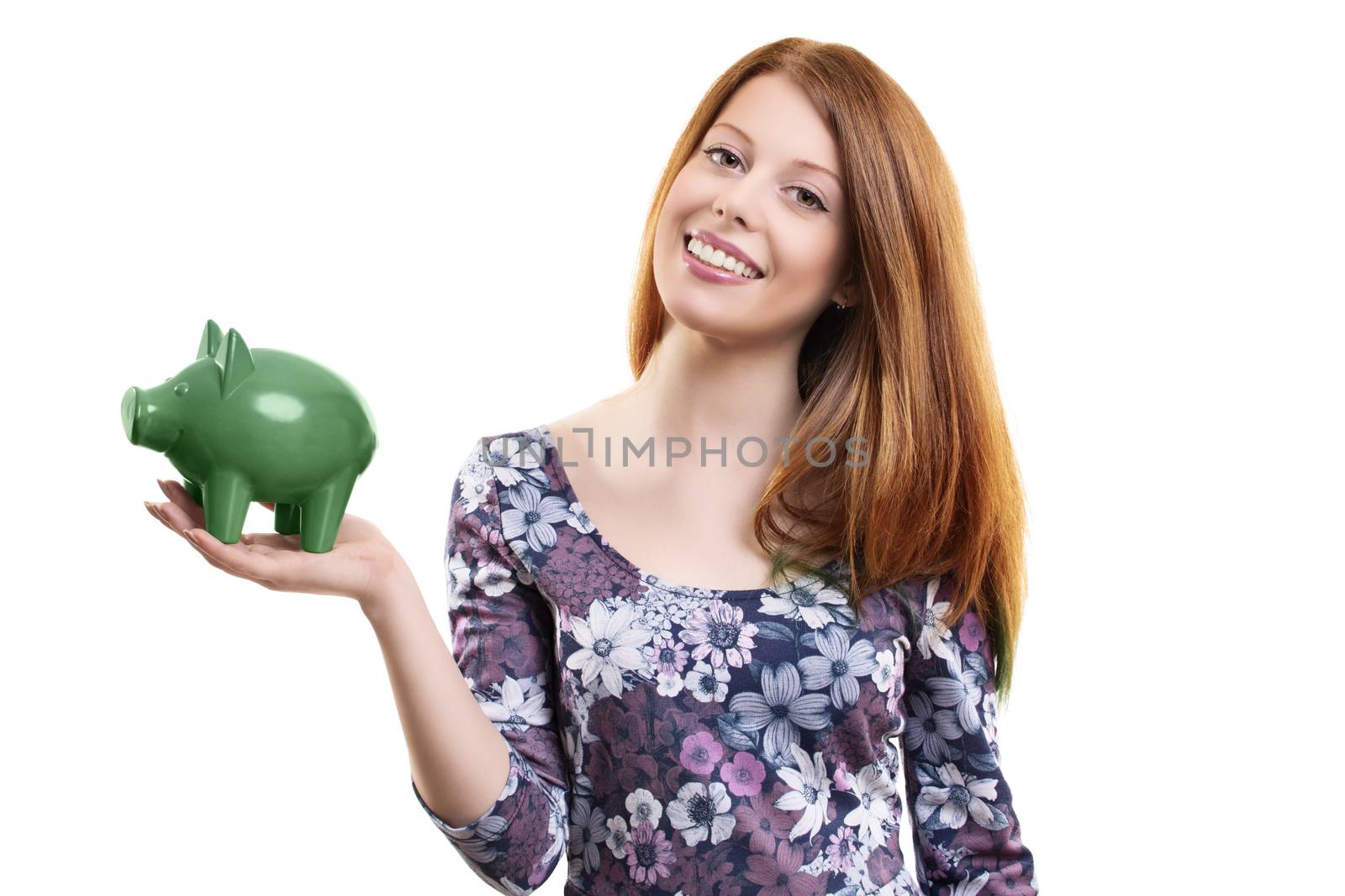 Portrait of a beautiful young woman holding a green piggy bank in her hands, isolated on white background. Saving concept. Thinking of the future concept.