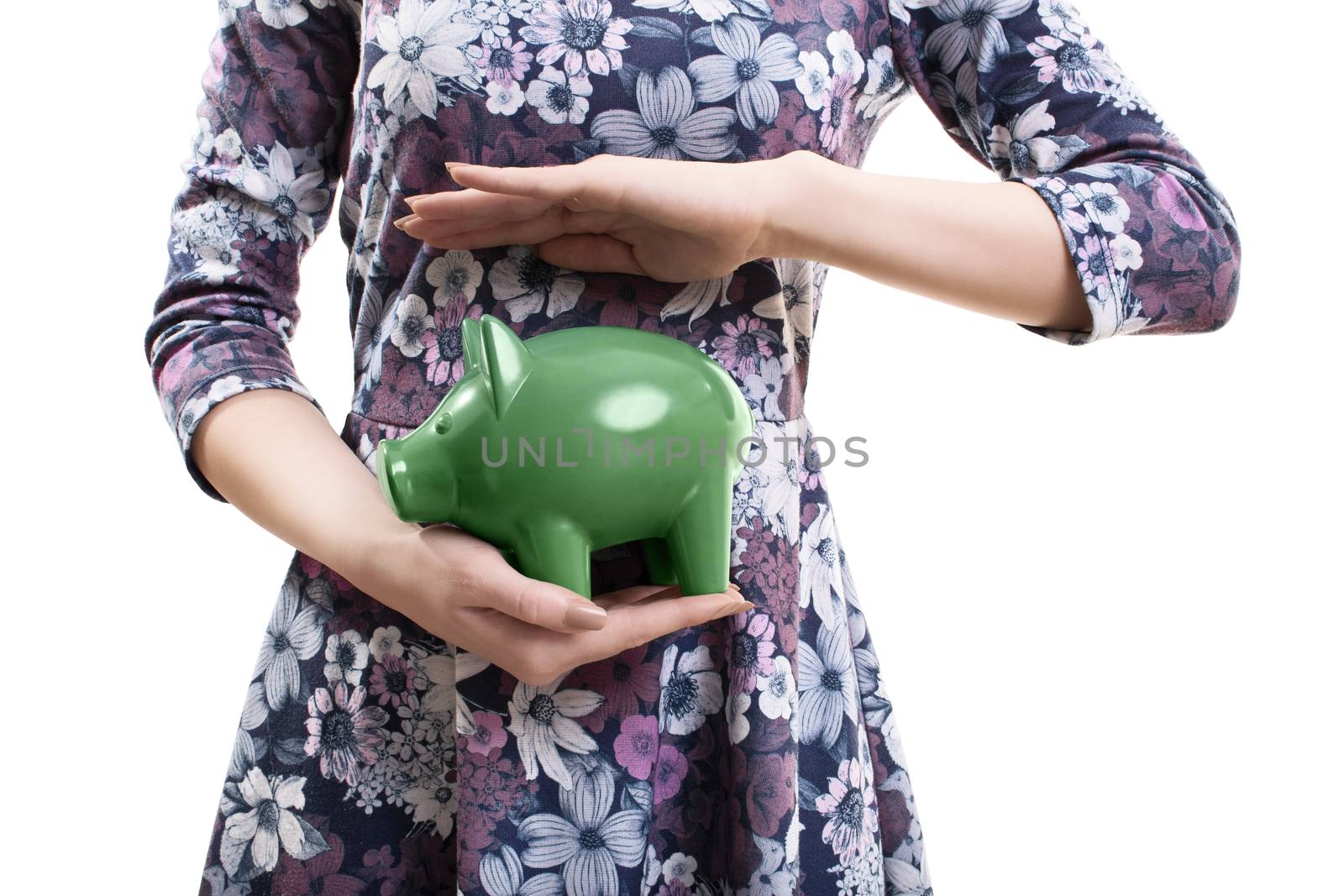 Close up of an unrecognizable young woman holding a green piggy bank in her hands, isolated on white background. Saving concept. Thinking of the future concept.