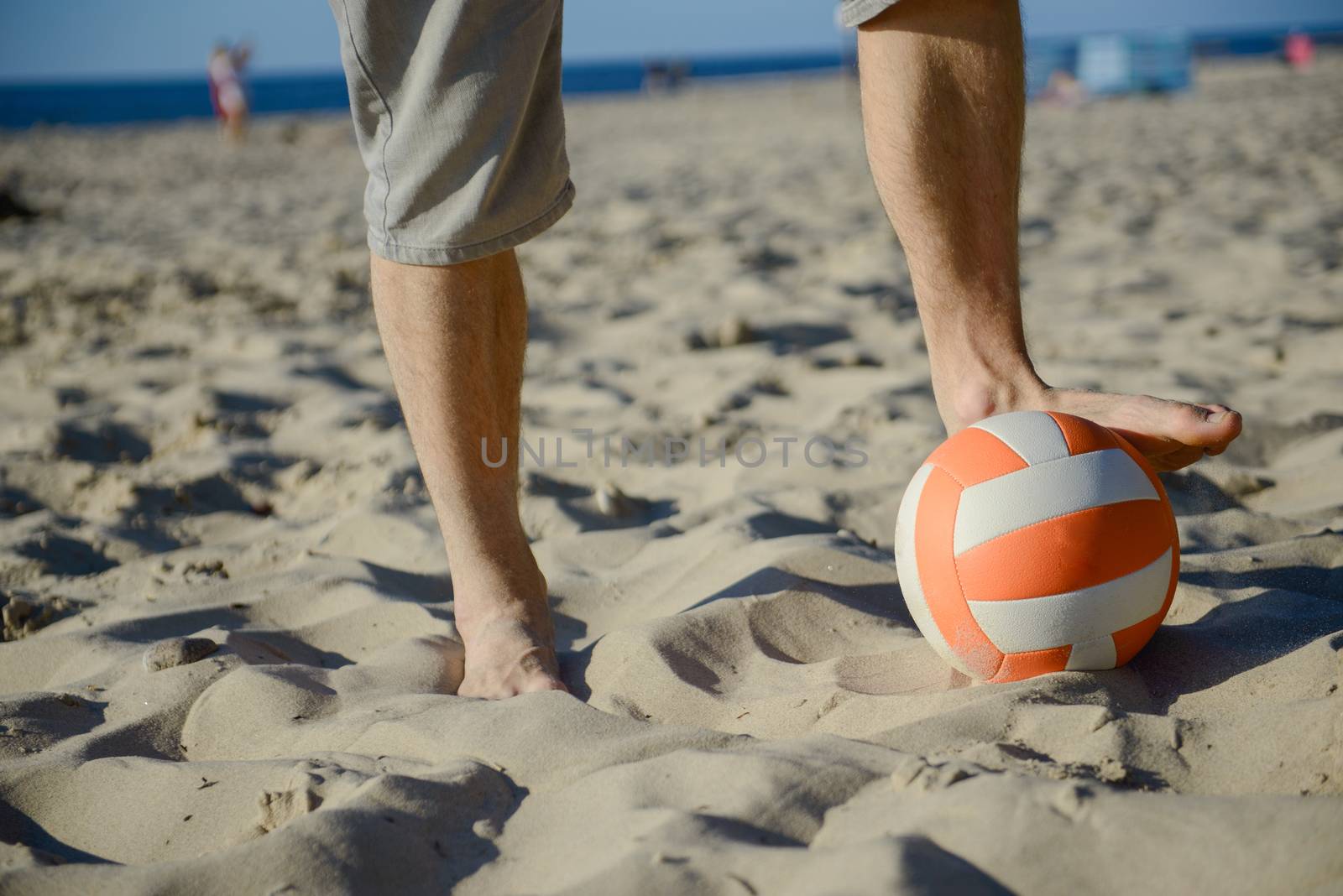 man playing soccer on beach with dribble skill and ball on vacation
