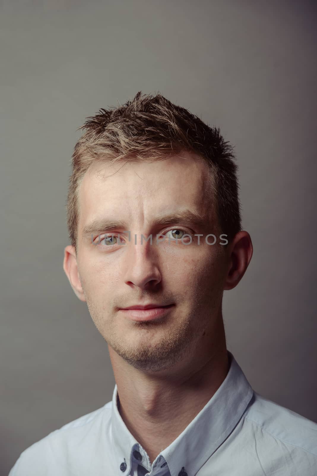 Portrait of a smart serious young man.
