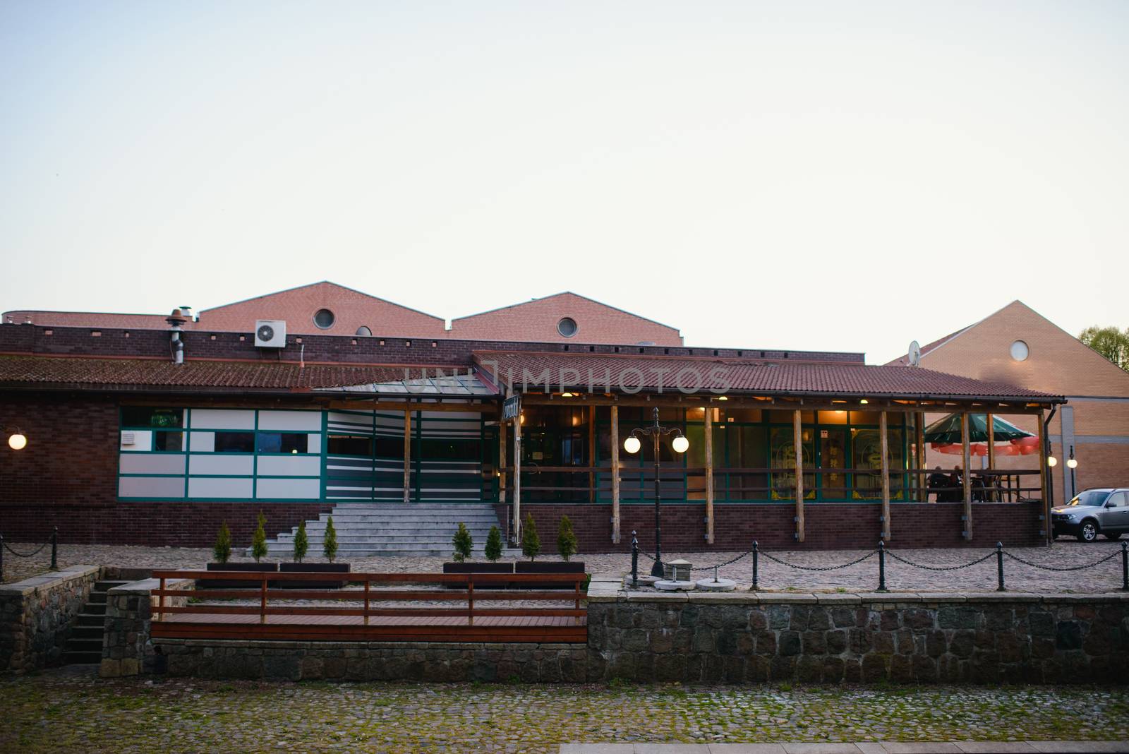 a riverside bar building in town at dusk