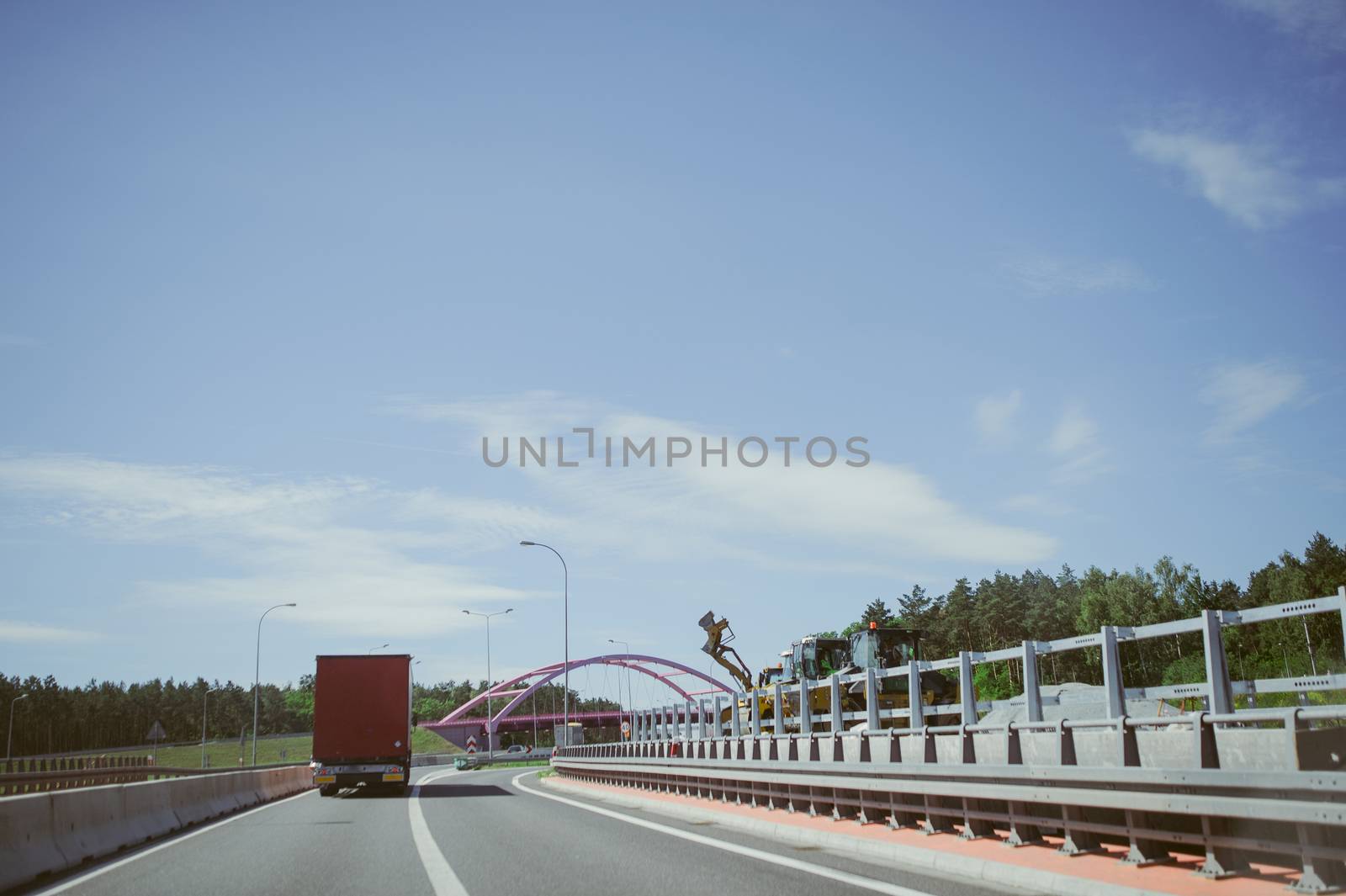 car and blue sky with blurred clouds.