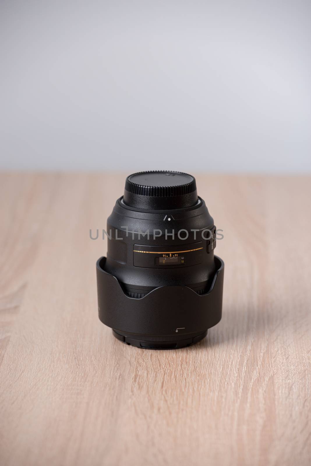 Closeup of a photographic lens on wooden table