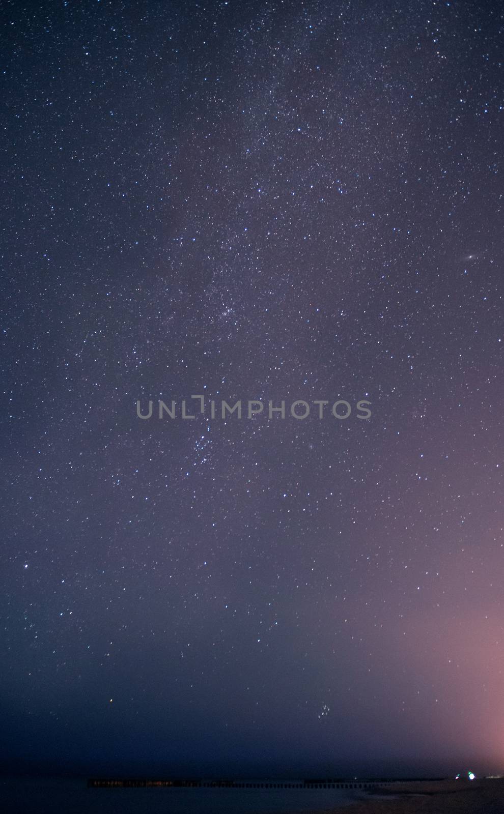 A photograph of a startrails in the sky under the starry sky