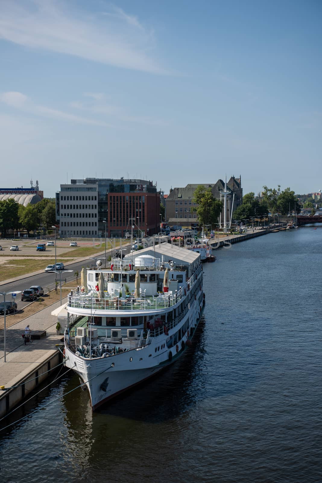 Modern and wooden marina club building in Szczecin, Poland. Boats, motorboat moored at the bank.