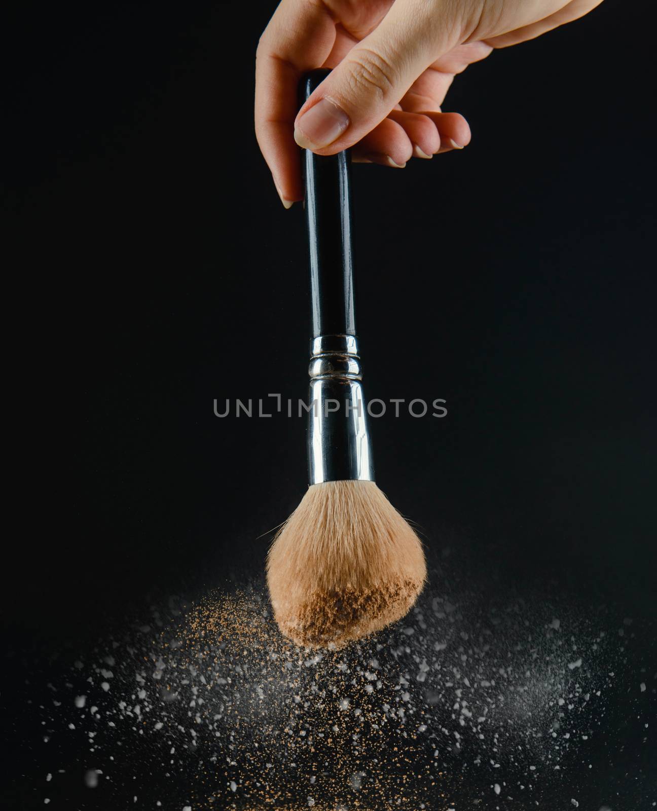 close up of a make up powder and a brush. makeup brush with powder foundation