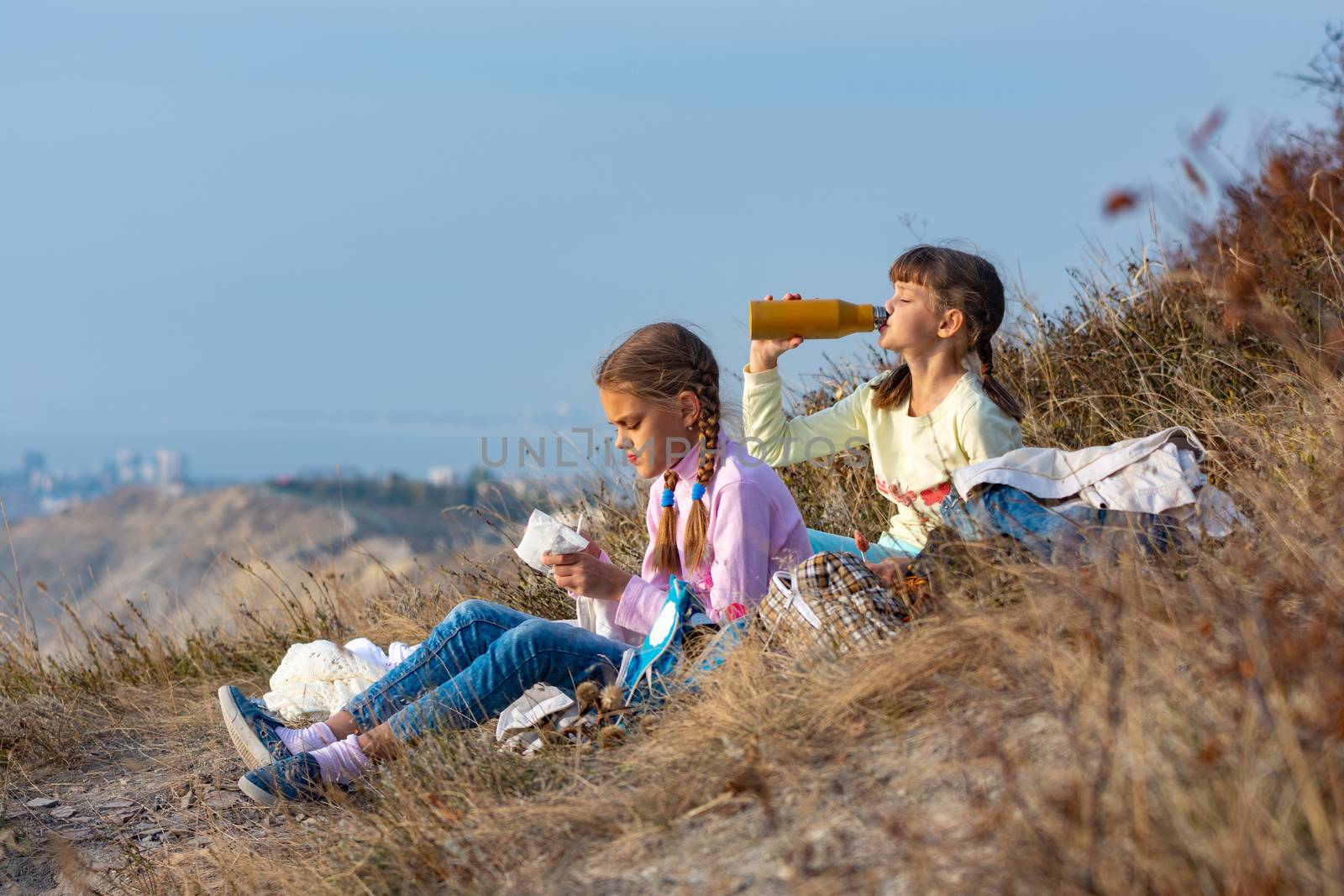 Girls on a rest on a halt and drink water