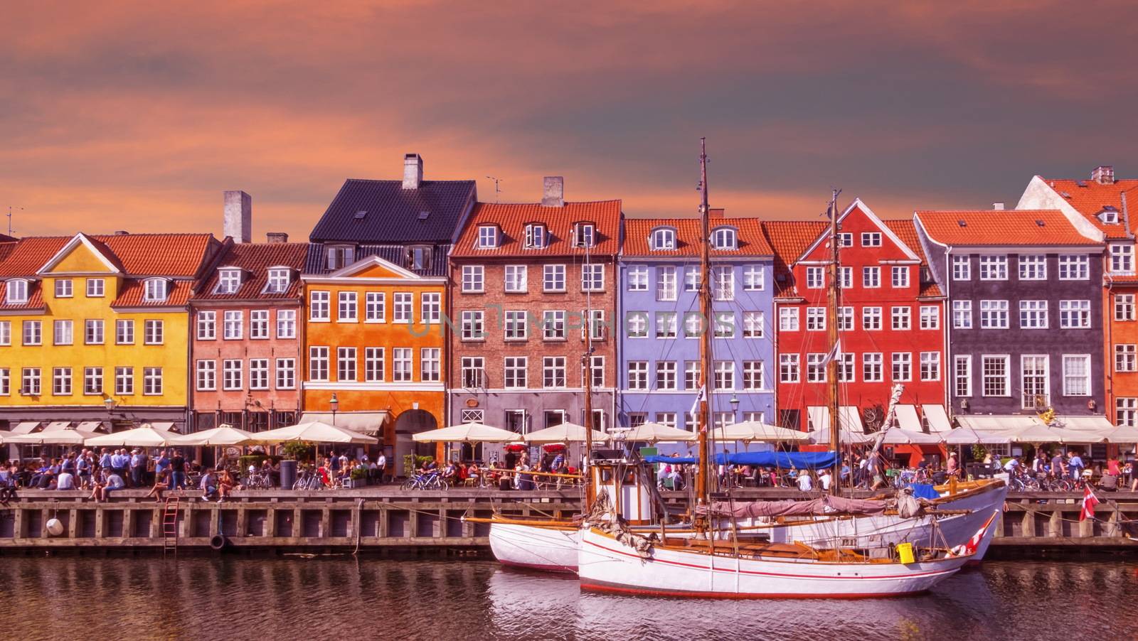 Scenic summer view of color buildings and boats of Nyhavn in Copenhagen, Denmark