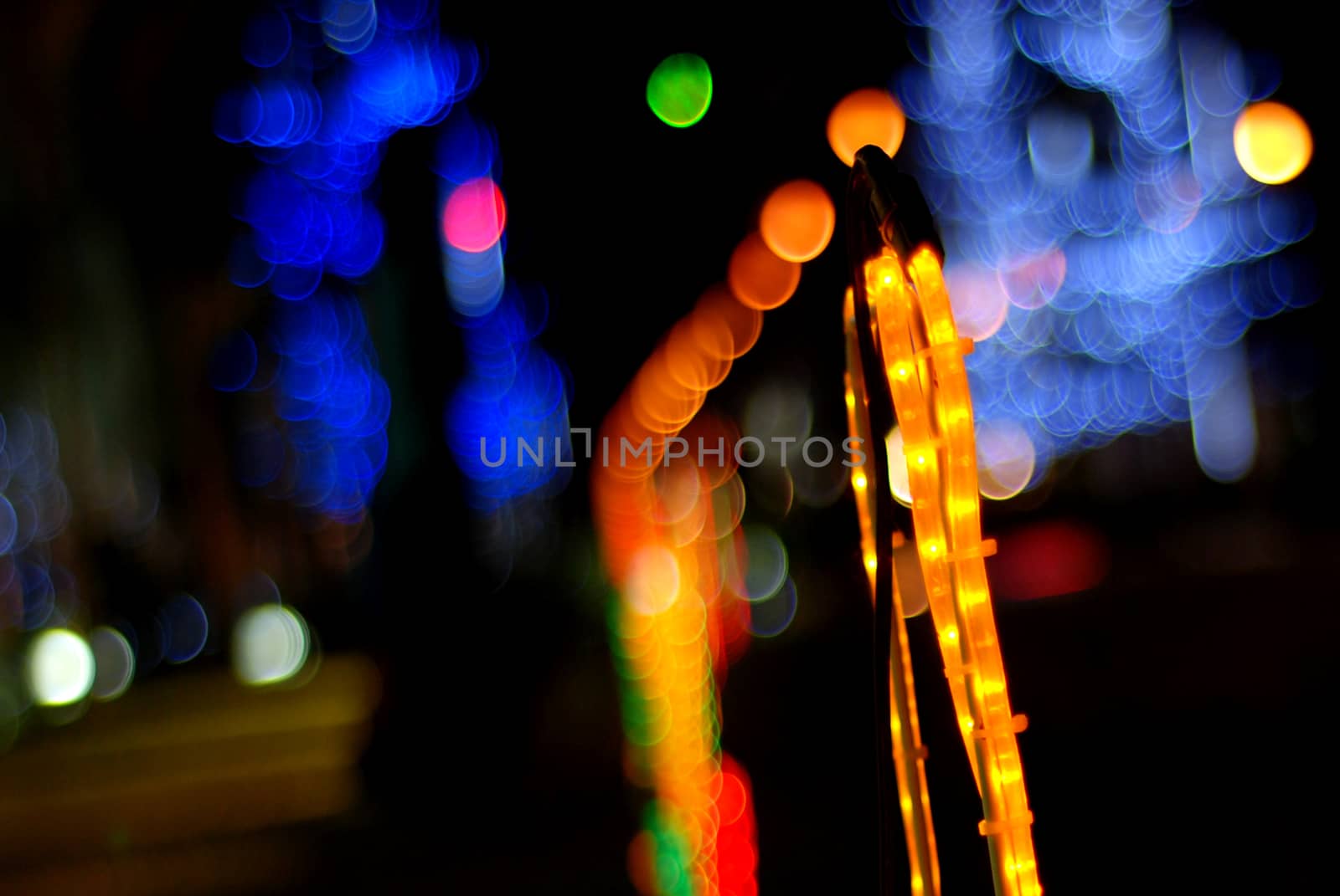 Blurred Christmas lights in the night on a black background, bokeh. by Sthanakon_s