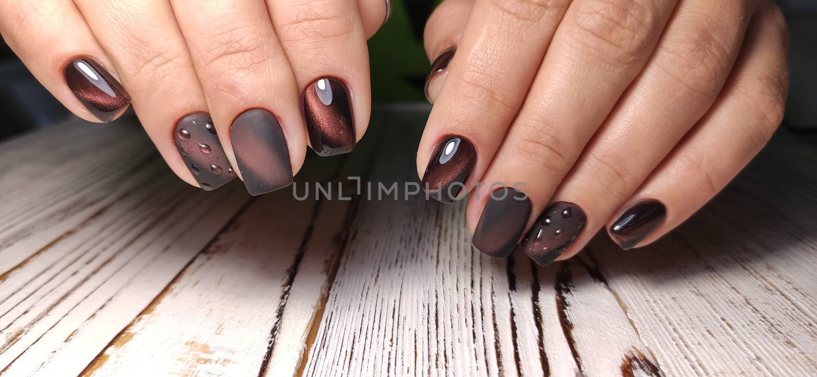 Gray striped nail design on female hand close up 2019