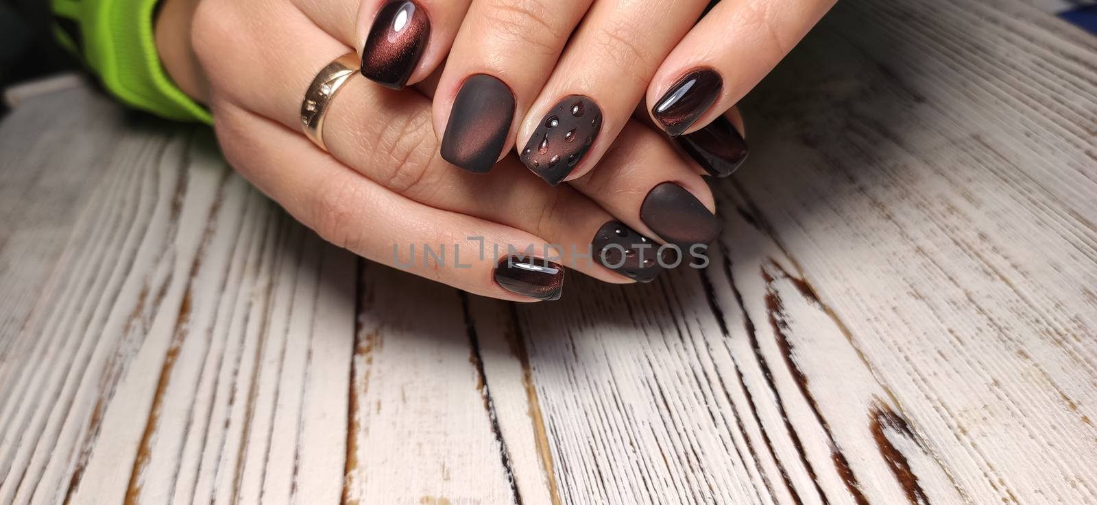 Gray striped nail design on female hand close up. by SmirMaxStock
