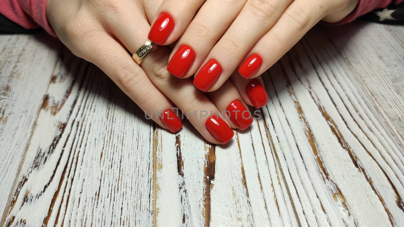 Glamorous luxurious brown crocodile manicure with gold plated women's nails closeup.