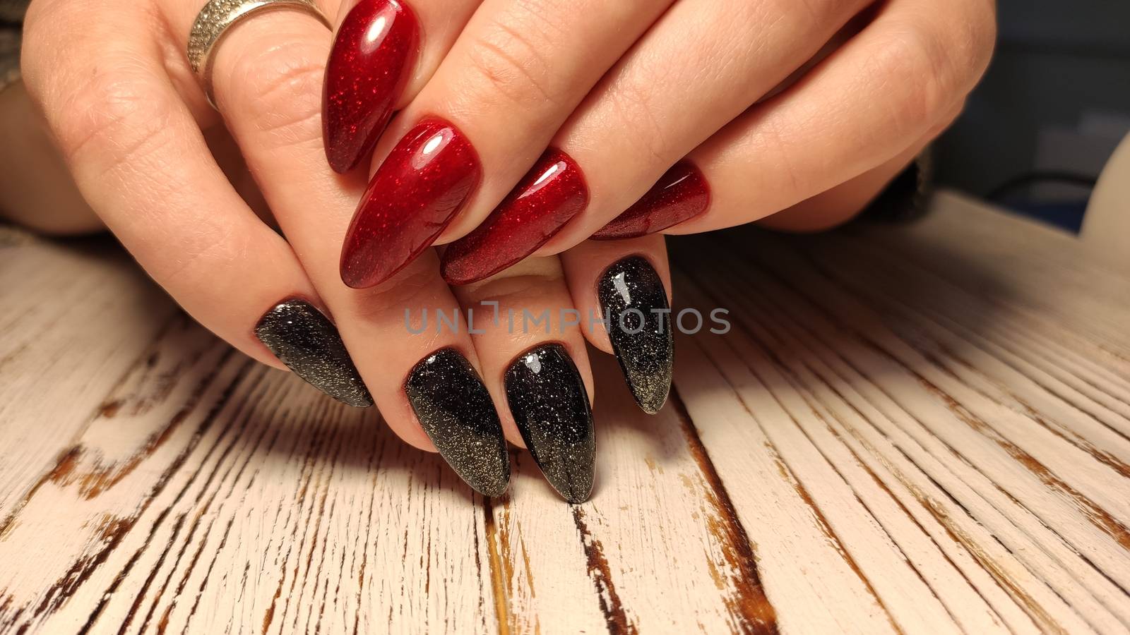 Glamorous luxurious brown crocodile manicure with gold plated women's nails closeup.