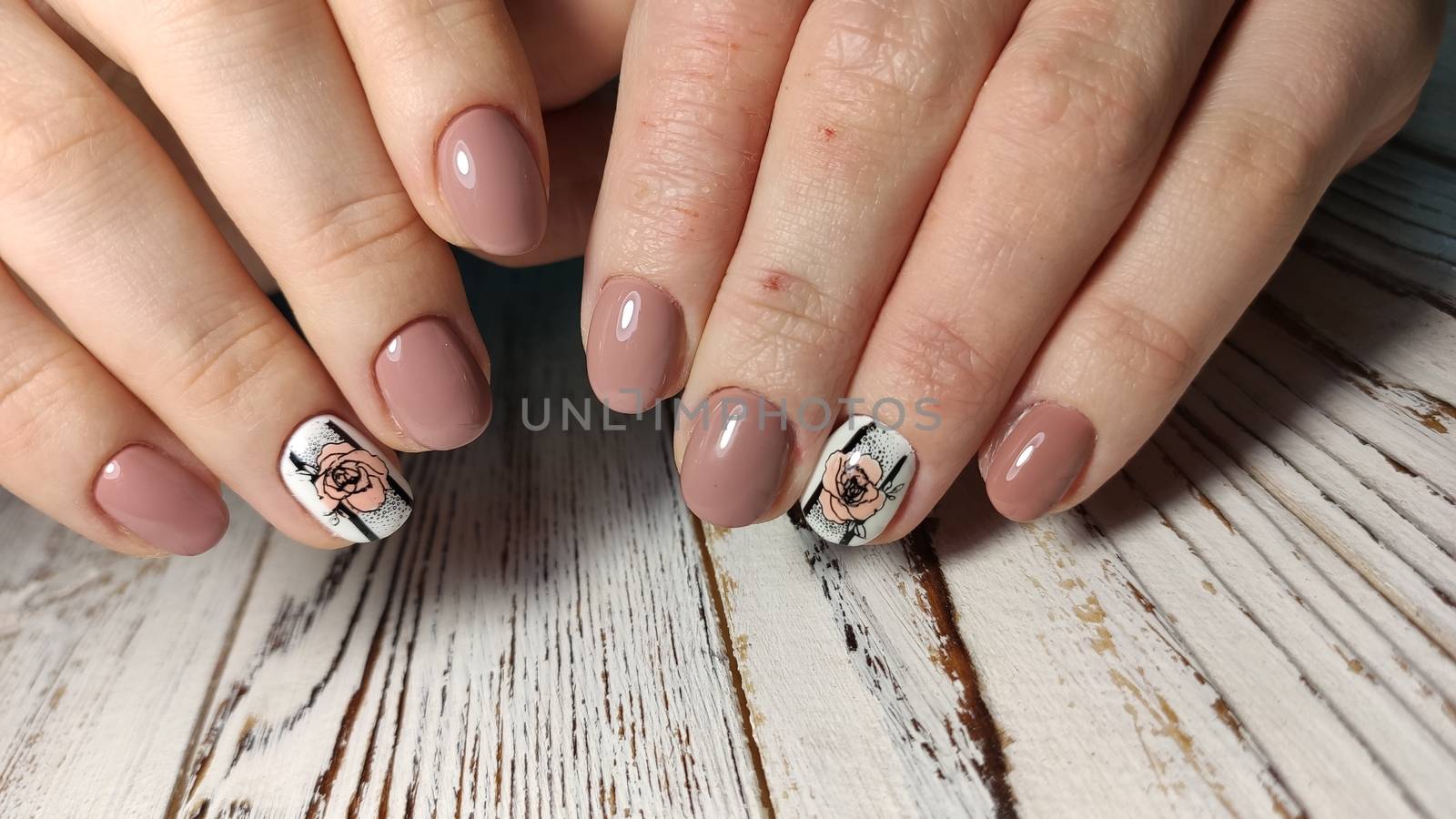 Glamorous luxurious brown crocodile manicure with gold plated women's nails closeup.