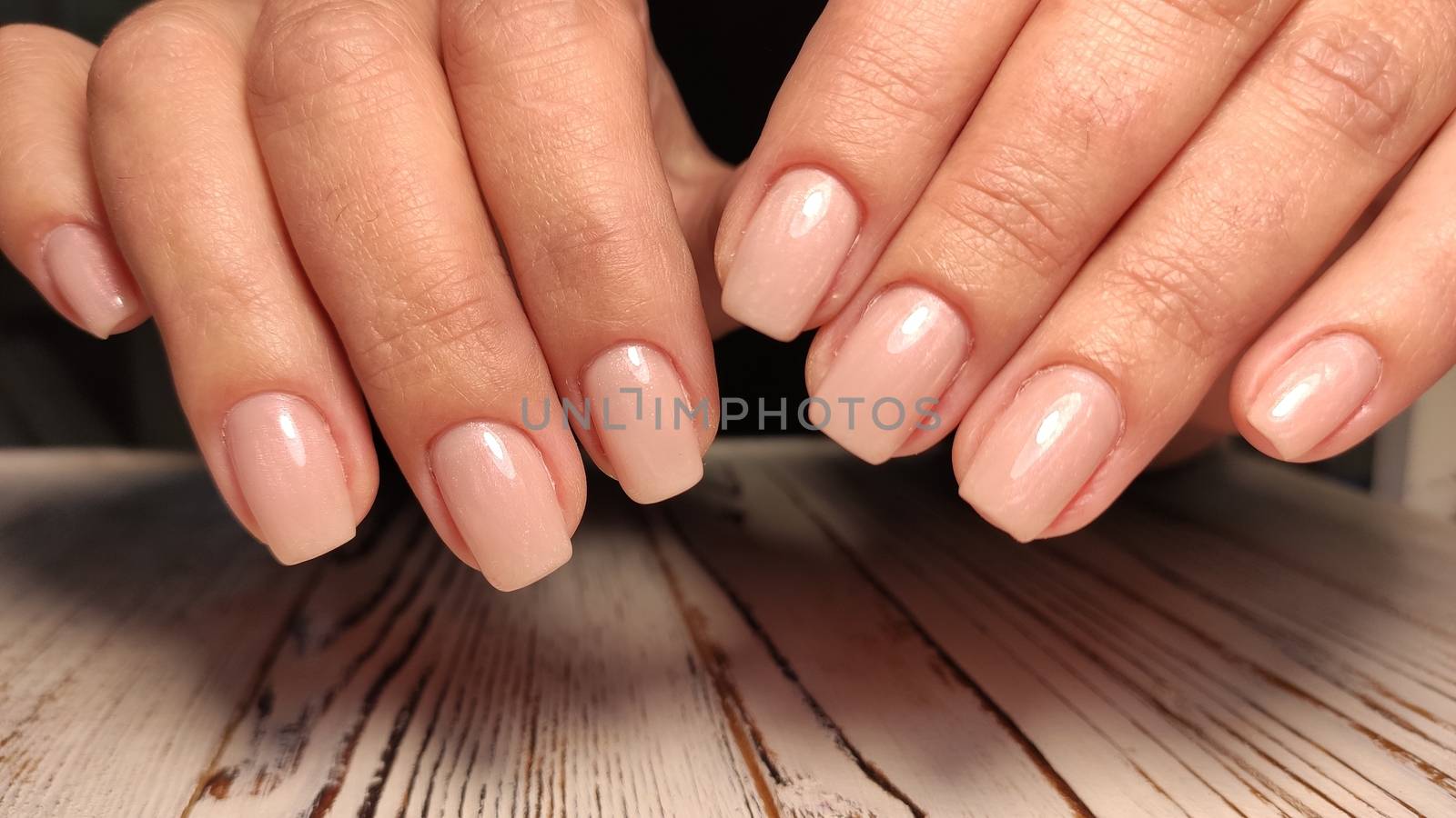 beautiful gel lacquer manicure on a textured trendy background by SmirMaxStock