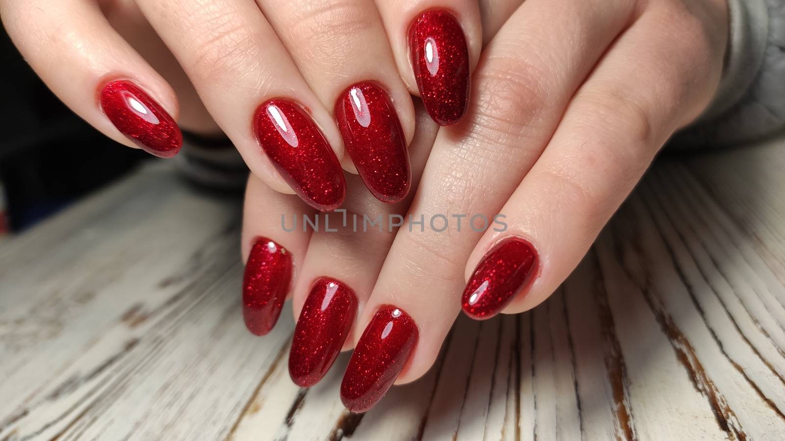 Manicured nails colored with red nail polish by SmirMaxStock